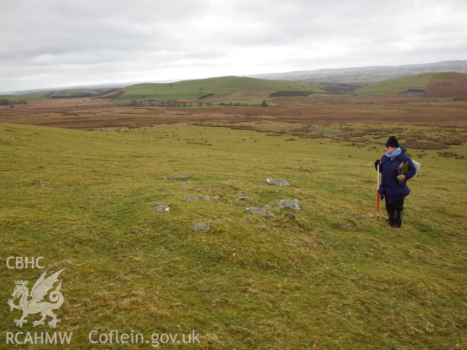 Low, grassed-over stone cairn, looking southwest.