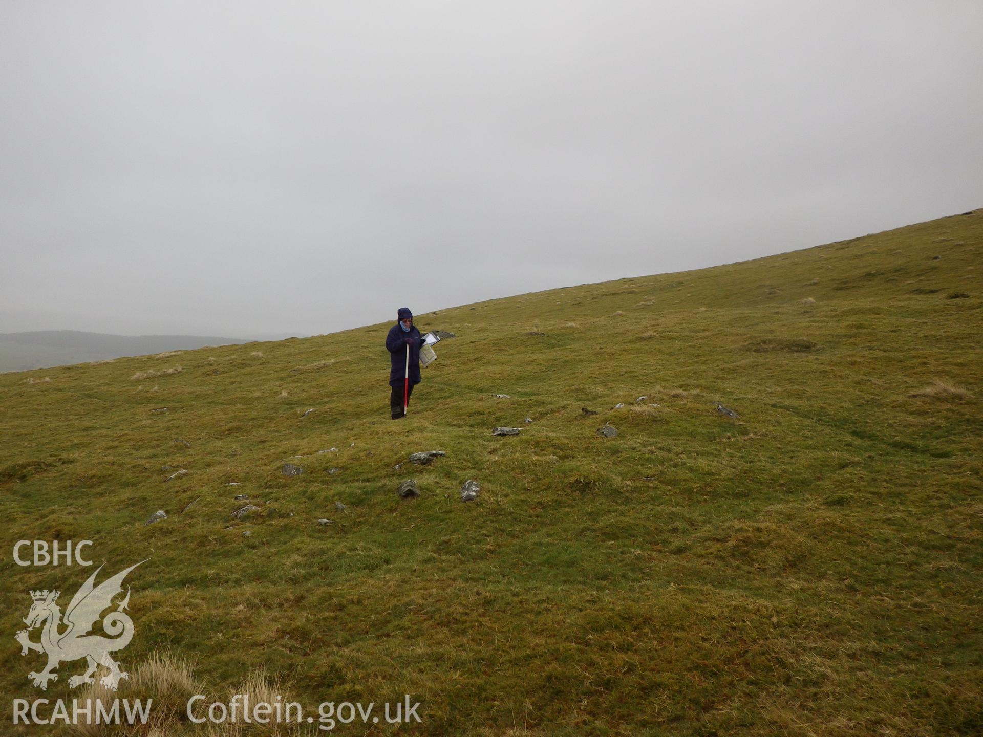 Low, grassed-over stone cairn, looking east northeast.