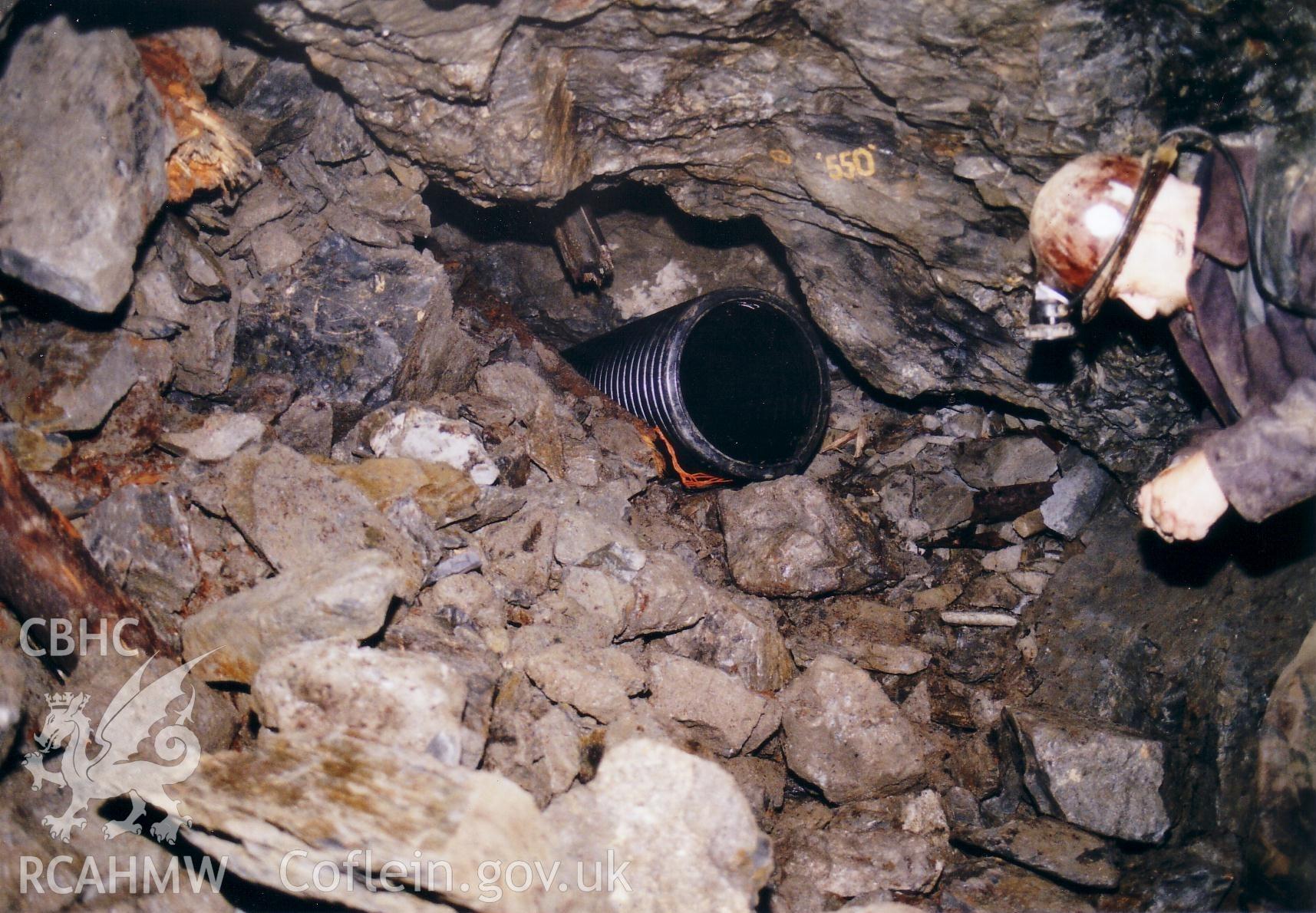 Plastic pipe being  inserted into main junction after collapse to maintain access to workings