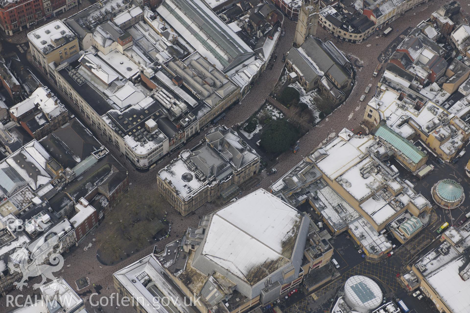 Cardiff central library, St John the Baptist church and St David's shopping centre, Cardiff. Oblique aerial photograph taken during the Royal Commission?s programme of archaeological aerial reconnaissance by Toby Driver on 24th January 2013.