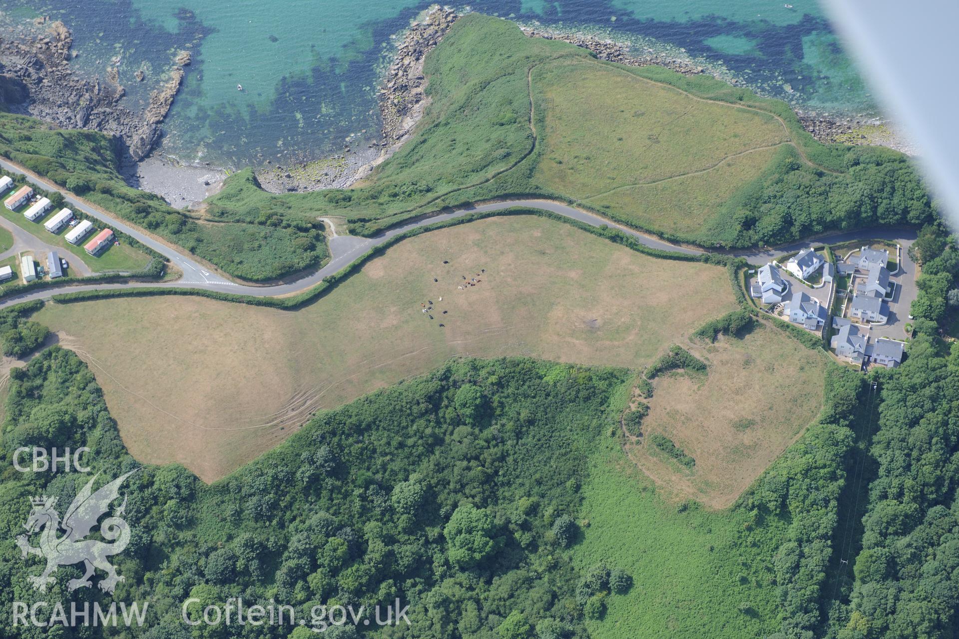 Woodlands defended enclosure, Little Haven. Oblique aerial photograph taken during the Royal Commission?s programme of archaeological aerial reconnaissance by Toby Driver on 16th July 2013.