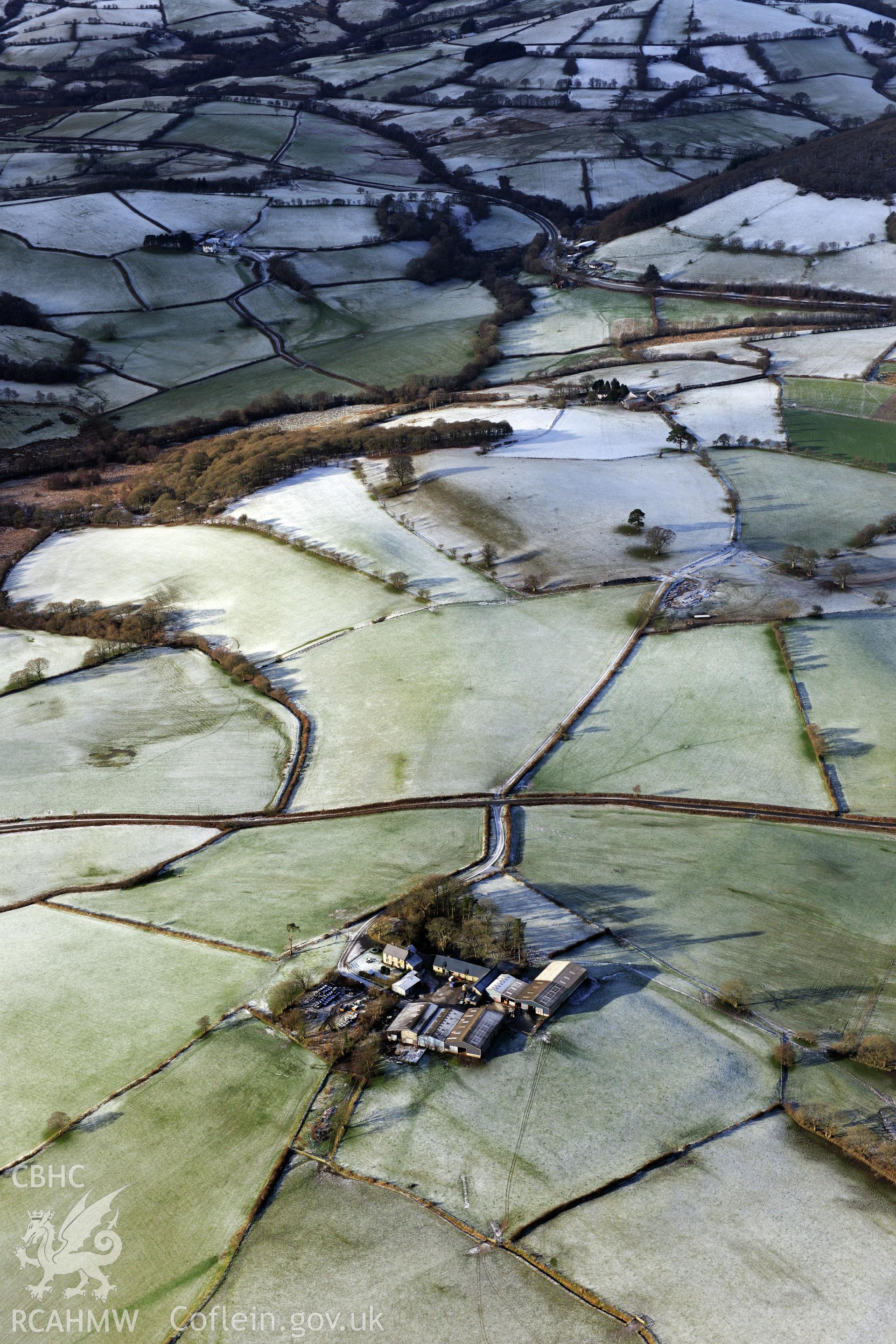 Twdin or Caerau Motte, Caerau Roman fort and military settlement, and the Roman road from Carmarthen to Castell Collen (RR623). Oblique aerial photograph taken during the RCAHMW?s programme of archaeological aerial reconnaissance by Toby Driver 15/01/2013.