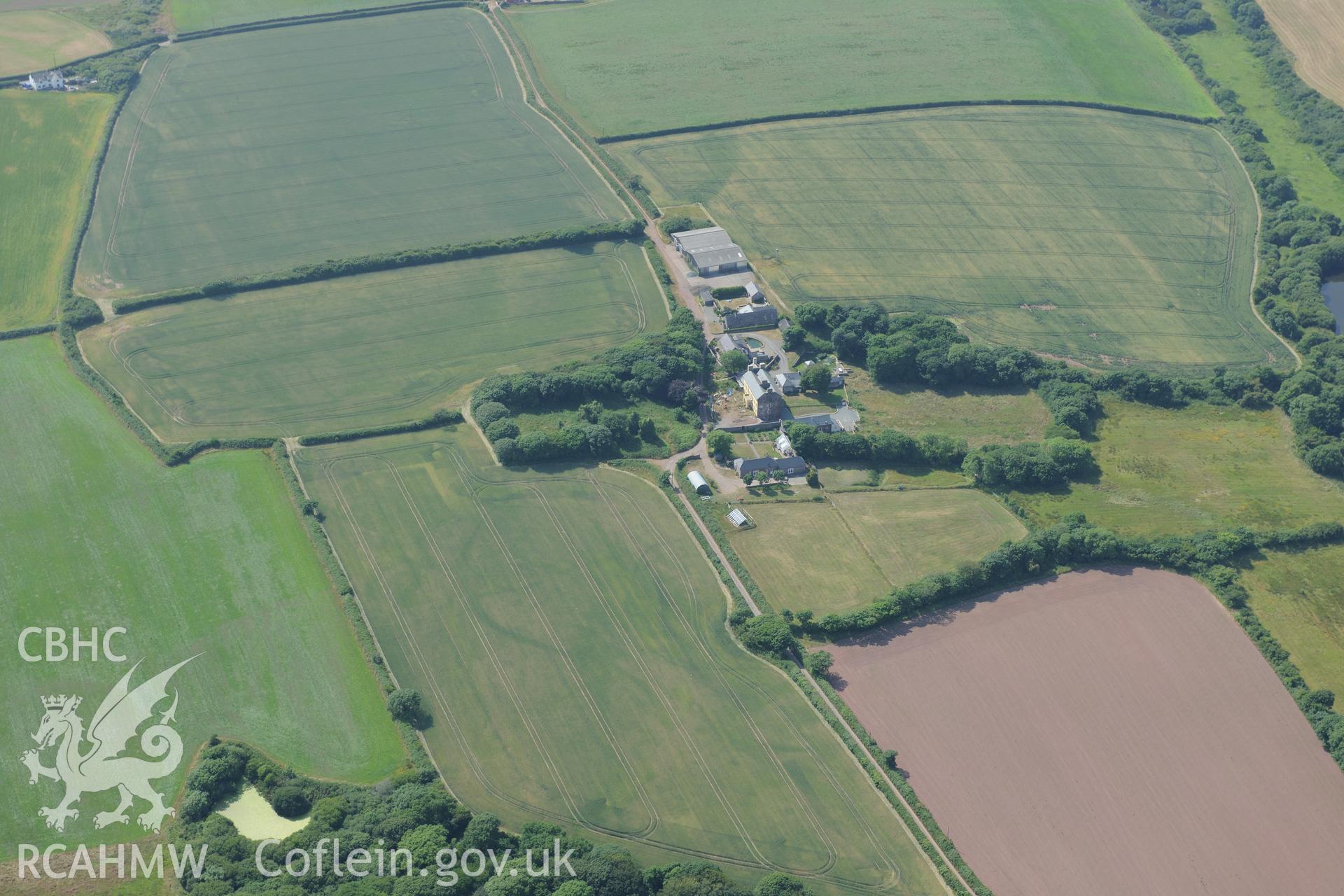 Butterhill farm with cropmarks east south south of the main farm buildings, near St Ishmaels. Oblique aerial photograph taken during the Royal Commission?s programme of archaeological aerial reconnaissance by Toby Driver on 16th July 2013.