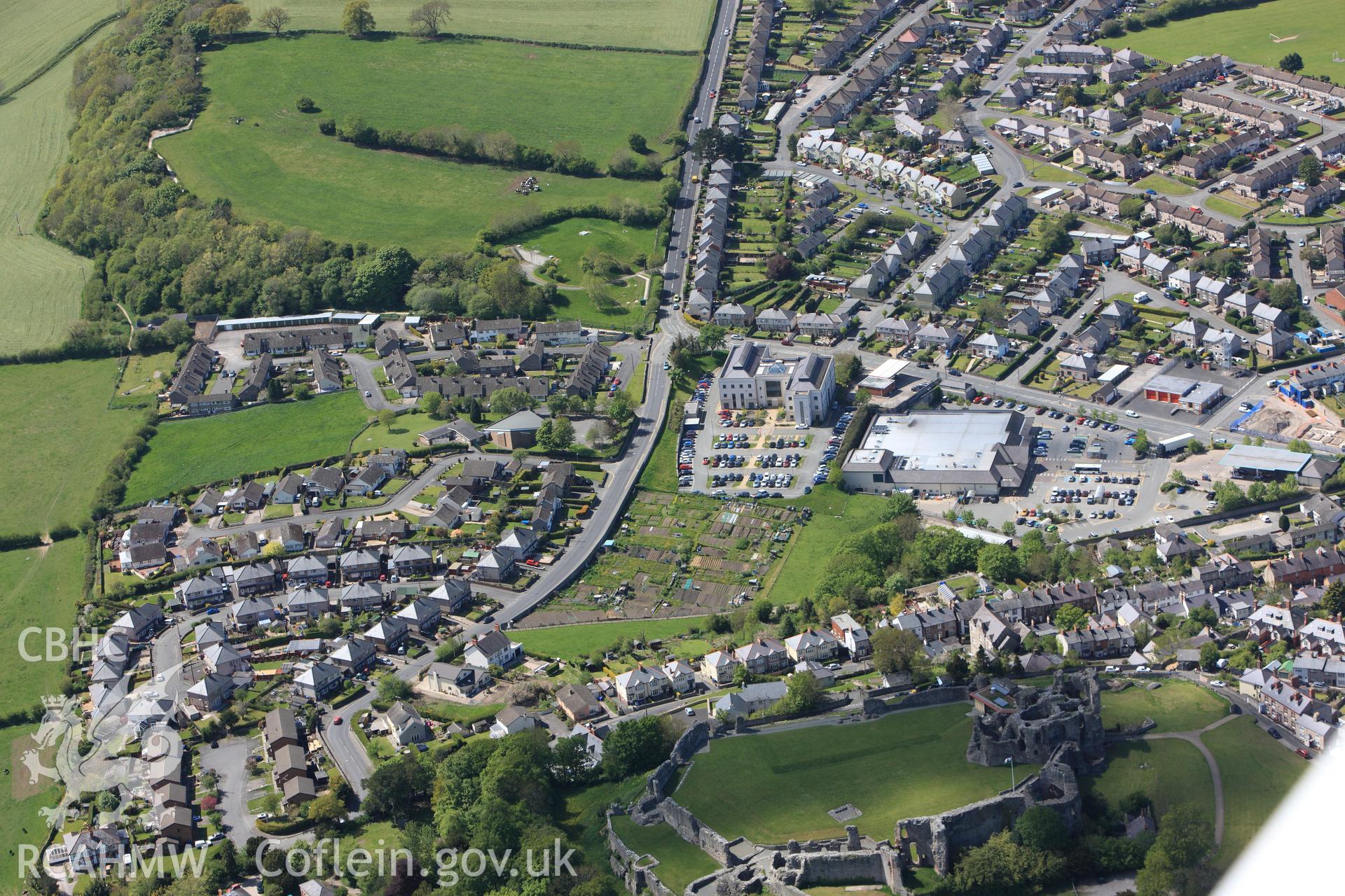 Denbigh Castle, St. Joseph's Catholic Church, Denbigh County Offices, and allotments, Denbigh. Oblique aerial photograph taken during the Royal Commission?s programme of archaeological aerial reconnaissance by Toby Driver on 22nd May 2013.