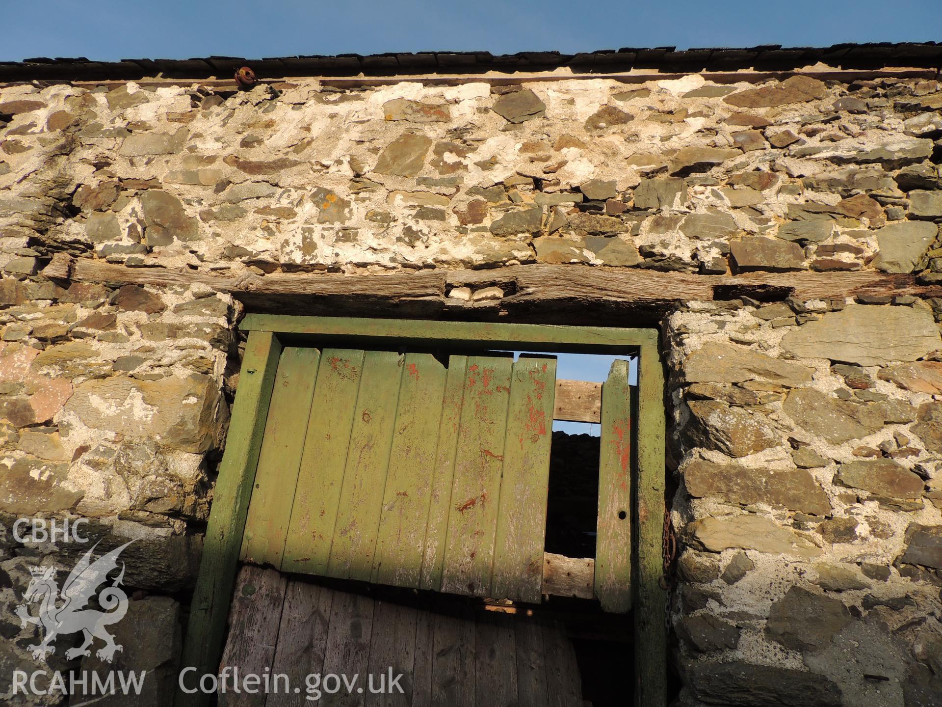 Worked linted above main entrance. Photograph taken as part of archaeological building survey conducted at Bryn Gwylan Threshing Barn, Llangernyw, Conwy, carried out by Archaeology Wales, 2017-2018. Report no. 1640. Project no. 2578.