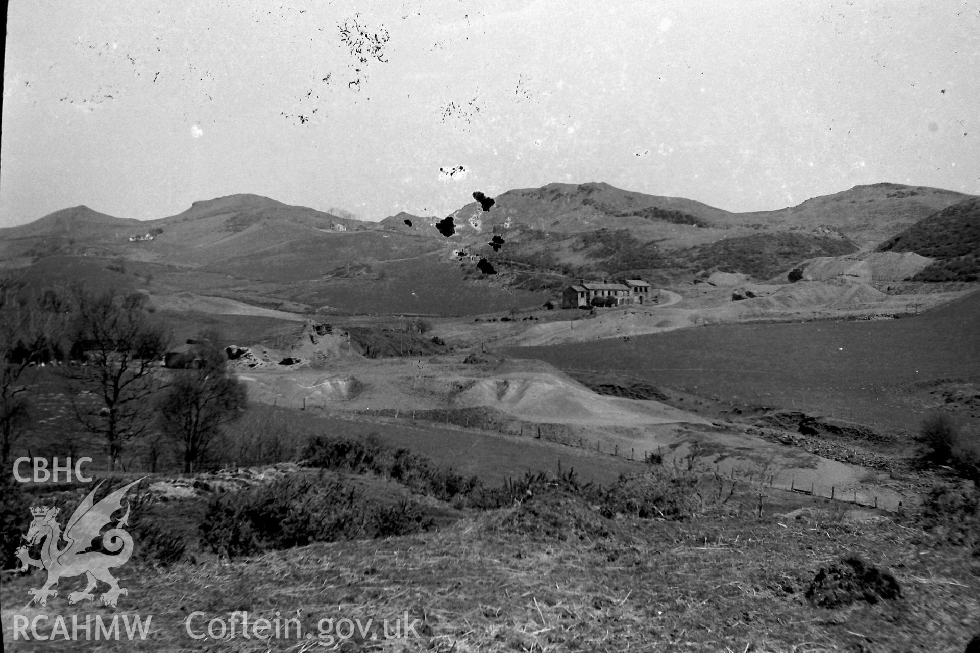 Digitised black & white photograph of Ystumtuen lead mine and dwellings. Produced during a Bachelor of Architecture dissertation entitled: 'The Form and Architecture of Nineteenth Century Industrial Settlements in Rural Wales' by Martin Davies, 1979.