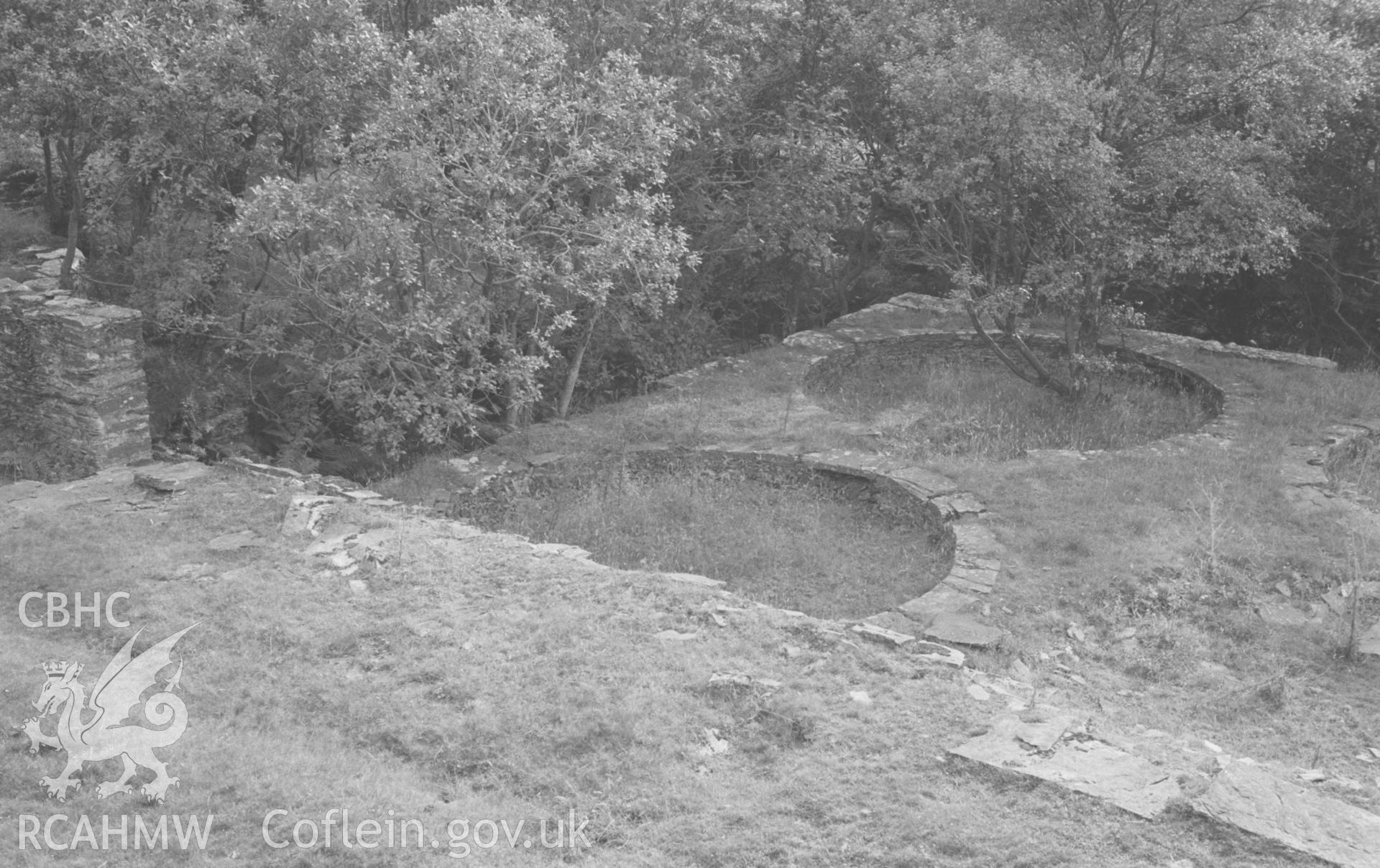 Digital copy of black & white negative showing two of the circular pits in the dressing floors, just below the main mine buildings at Bryndyfi Lead Mine. Photographed by Arthur O. Chater in August 1966 looking west from Grid Reference SN 683 934.