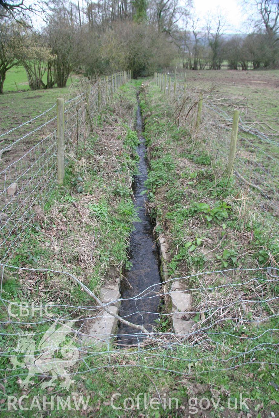 'Aqueduct feeder channel (looking west).' Digital colour photograph taken during site visit to land south of school lane, Penperlleni. Part of Archaeological Desk Based Assessment conducted by Iestyn Jones of Archaeology Wales, 2014.