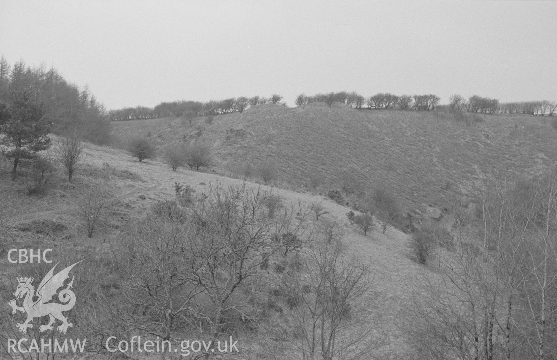 Digital copy of black & white negative showing Castell Moeddyn fach (centre, on skyline), south east of New Quay. Photographed in April 1964 by Arthur O. Chater from 50m south west of the site of Felin-Blaenau at Grid Reference SN 4752 5121, looking north.