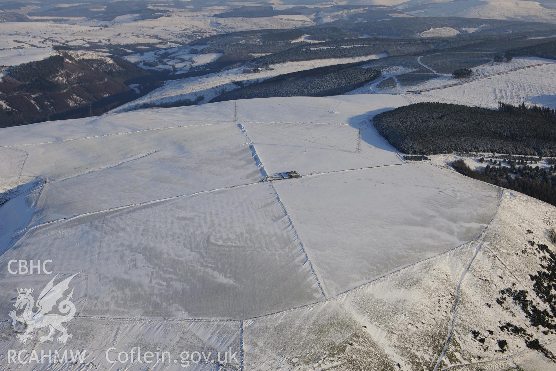 Mynydd Brombil enclosure earthwork and rabbit warren, on the eastern edge of Margam Forest, Margam, Port Talbot. Oblique aerial photograph taken during the Royal Commission?s programme of archaeological aerial reconnaissance by Toby Driver on 24th January 2013.