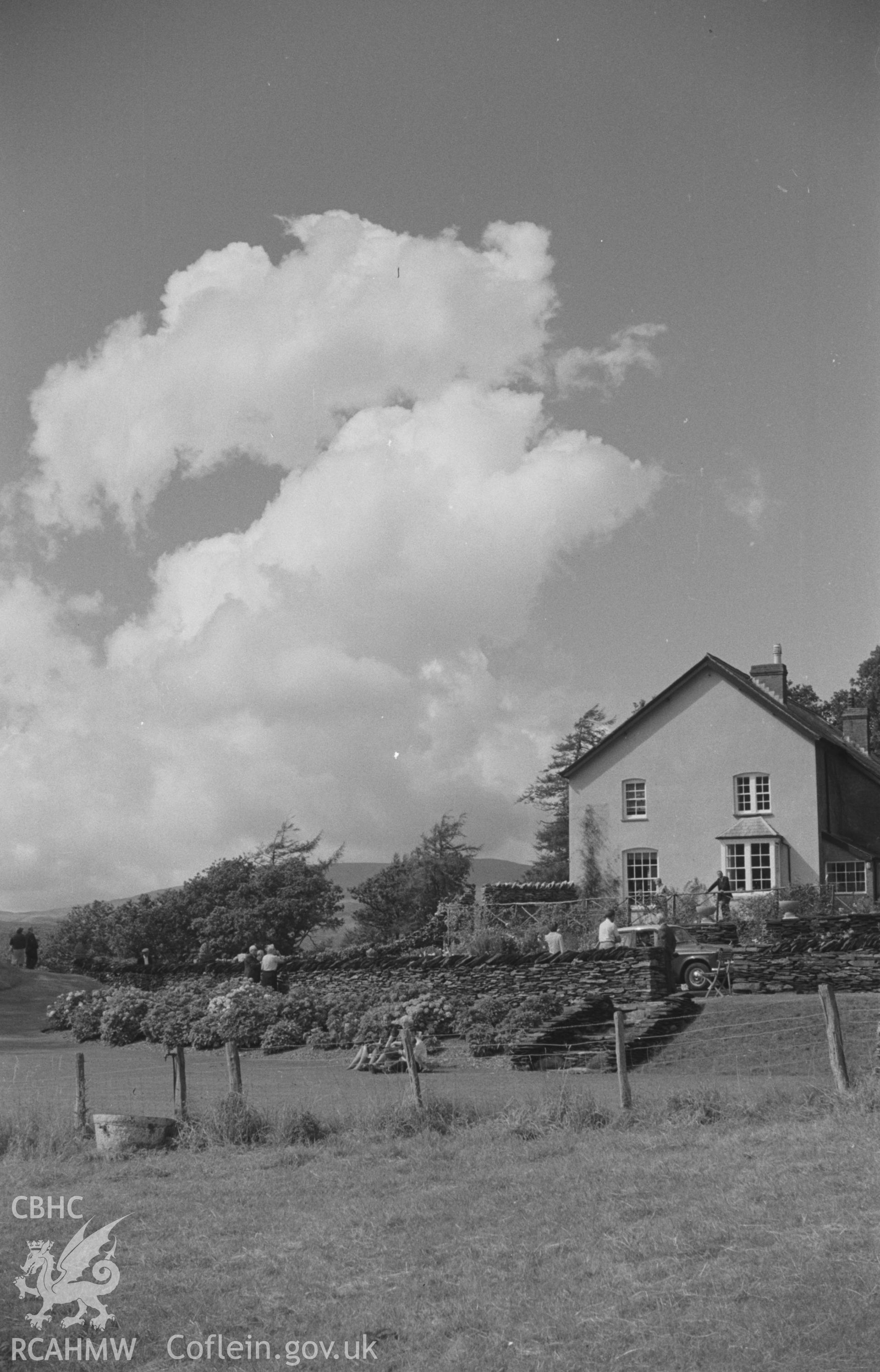 Digital copy of a black and white negative showing Cymerau farmhouse and garden, Eglwysfach, near Machynlleth. Photographed by Arthur O. Chater in August 1965 looking north north west from Grid Reference SN 6963 9626.