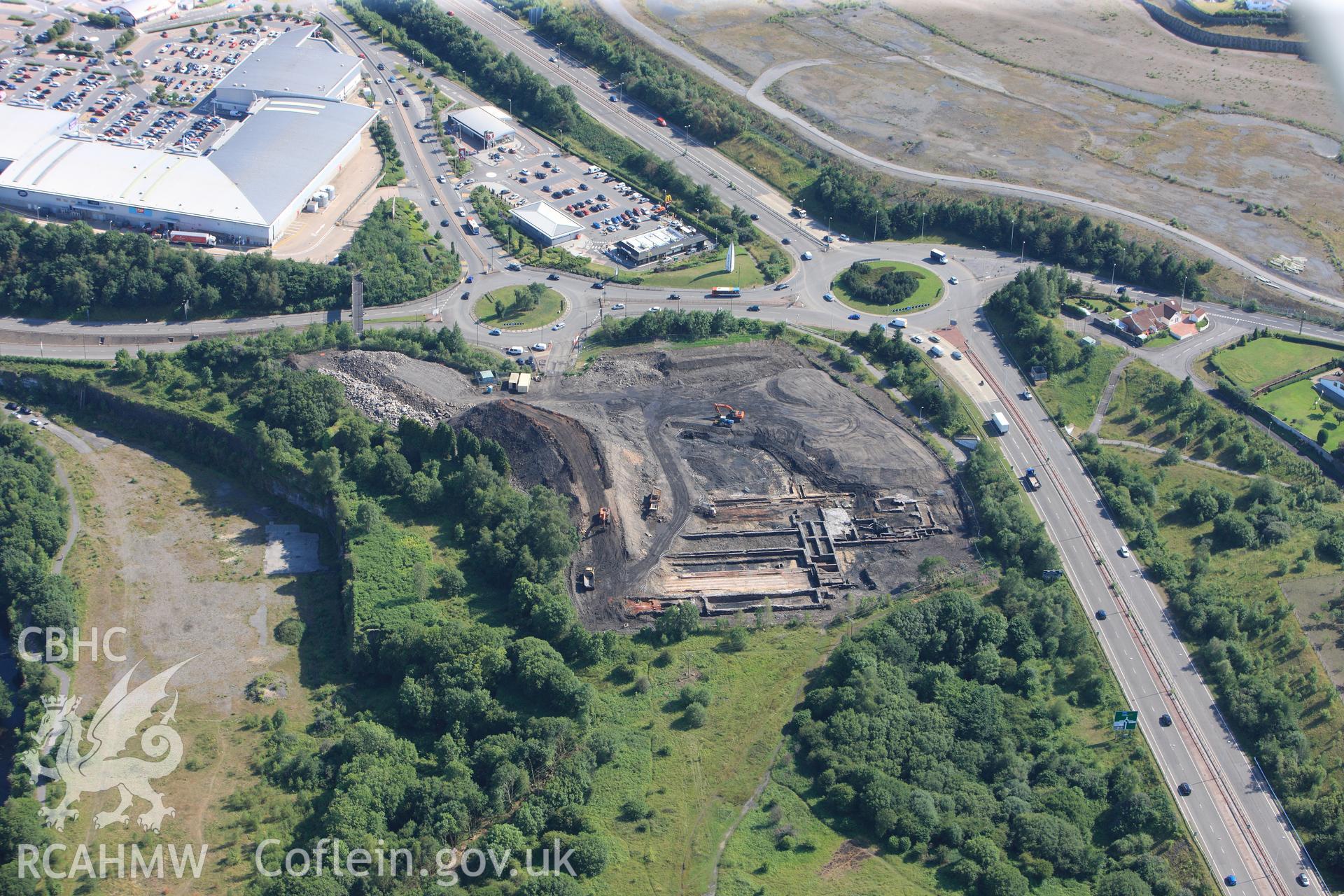 Site of former Rotax factory, Cyfarthfa Retail Park, and Cyfarthfa Ironworks including the remains of its blast furnaces, under excavation by Glamorgan-Gwent Archaeological Trust. Oblique aerial photograph taken during the Royal Commission?s programme of