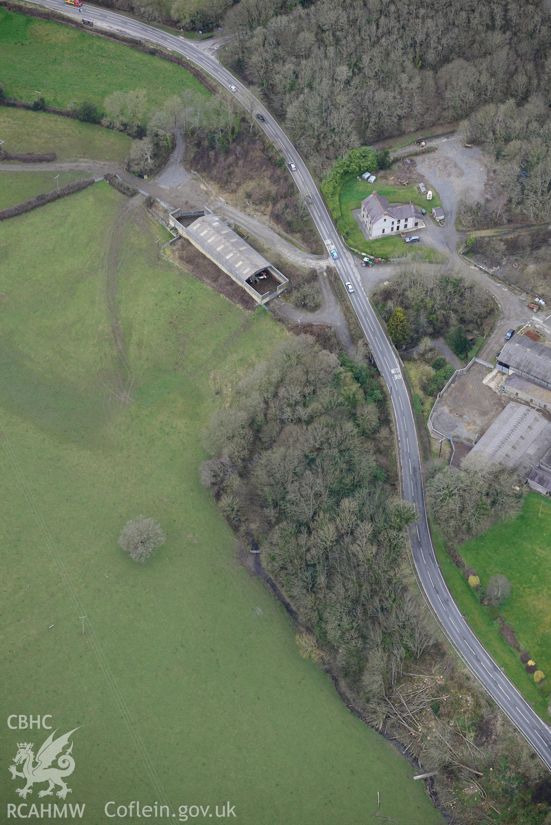 Llwyndunis castle mound and farm, Llechryd, near Cardigan. Oblique aerial photograph taken during the Royal Commission's programme of archaeological aerial reconnaissance by Toby Driver on 13th March 2015.