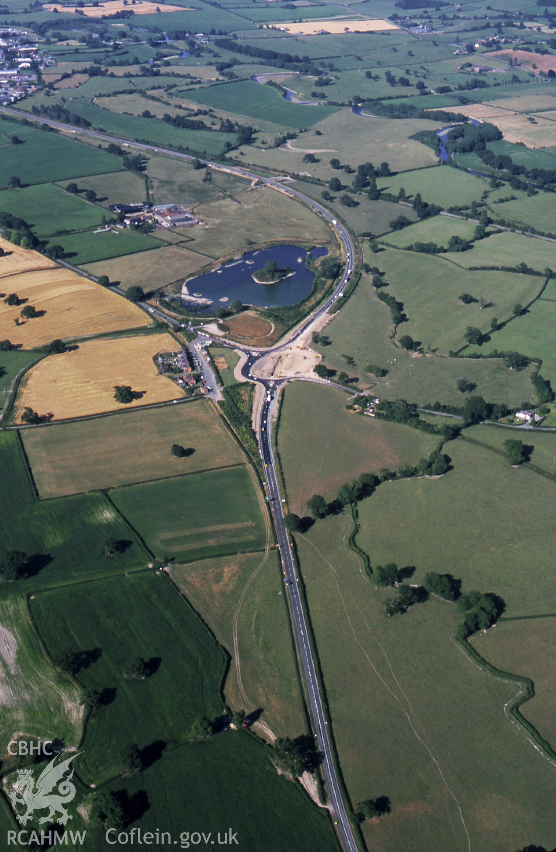 RCAHMW colour slide oblique aerial photograph of Sarn-y-bryn Caled Pit Circle, Welshpool, taken on 26/07/1999 by CR Musson