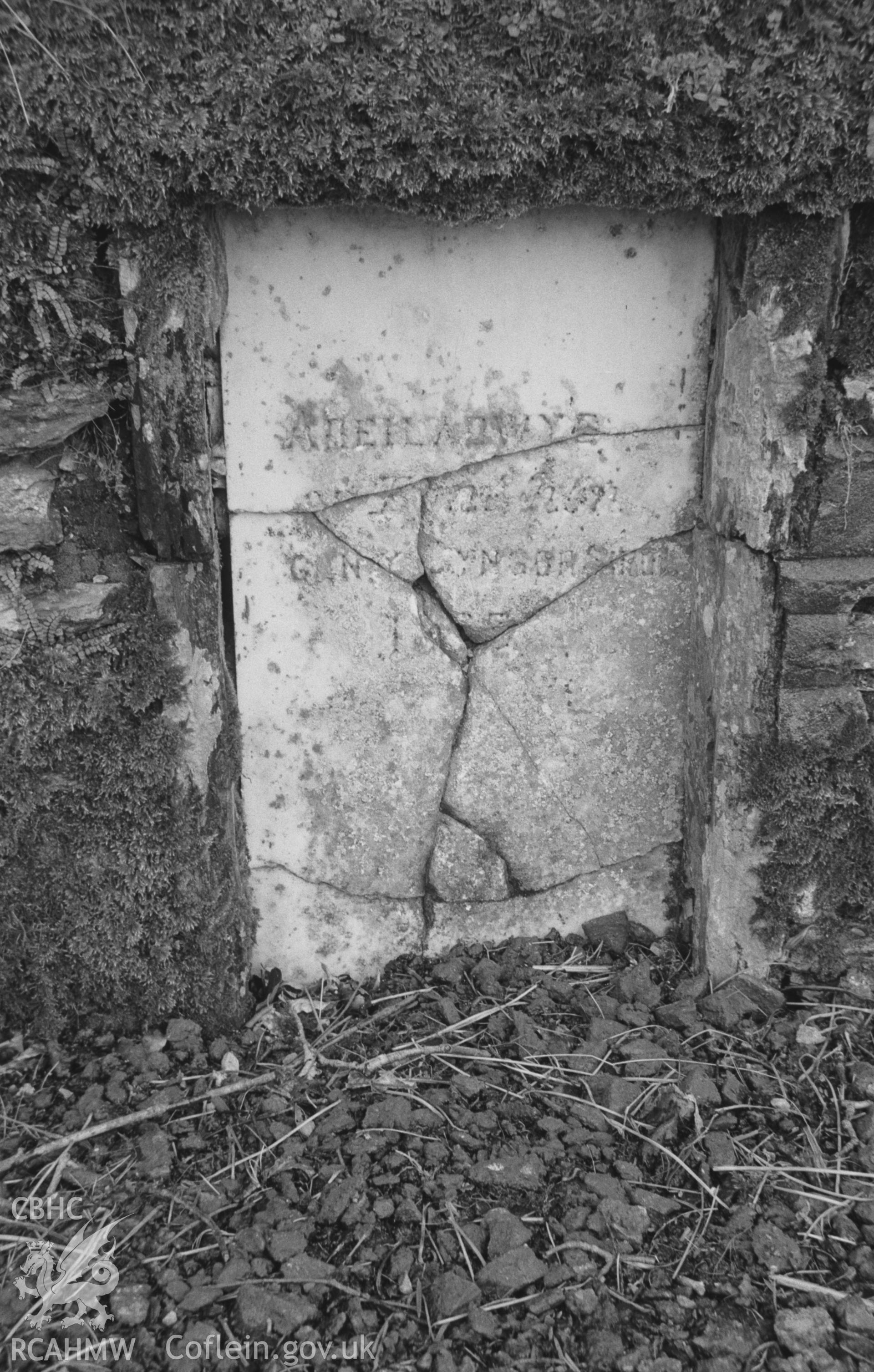 Digital copy of a black and white negative showing marble plaque in north west parapet of main road bridge over Afon Cerdin; the metal filling of the letters has entirely gone. Photographed by Arthur O. Chater in April 1966 from Grid Reference SN 382 495.