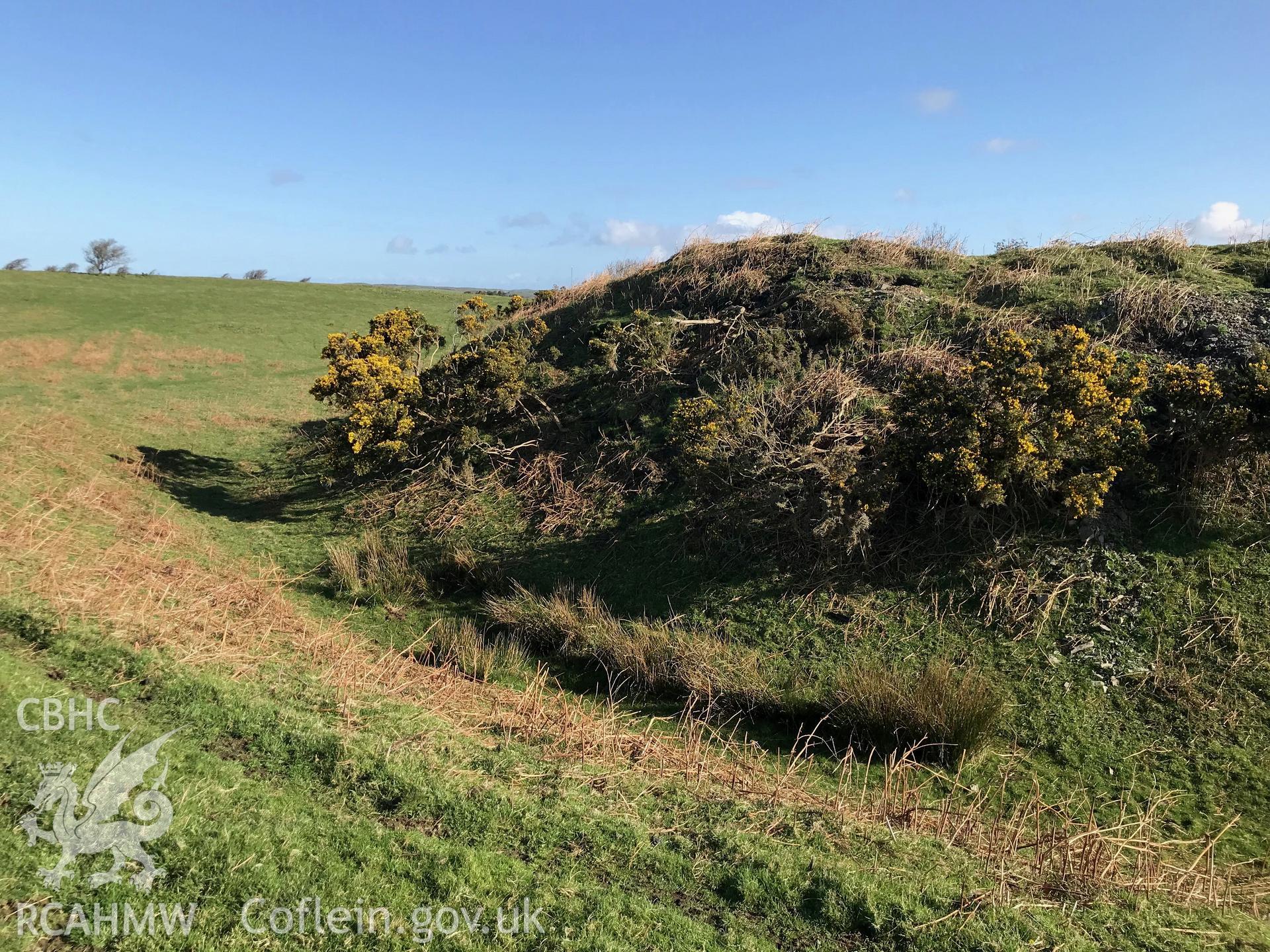 Colour photograph of view of the castle earthworks at Caer Penrhos, taken by Paul R. Davis on 24th March 2019.