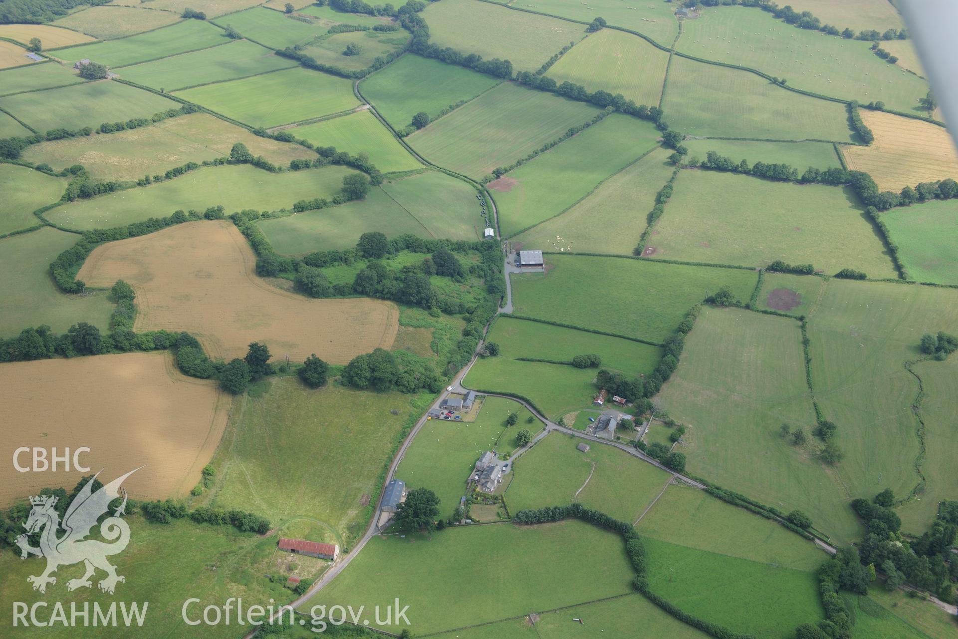 Pen-y-Gaer Roman fort, with the modern Pen-y-Gaer farm (on the right) and Greenhill farmstead (on the left). Oblique aerial photograph taken during the Royal Commission?s programme of archaeological aerial reconnaissance by Toby Driver on 1st August 2013.