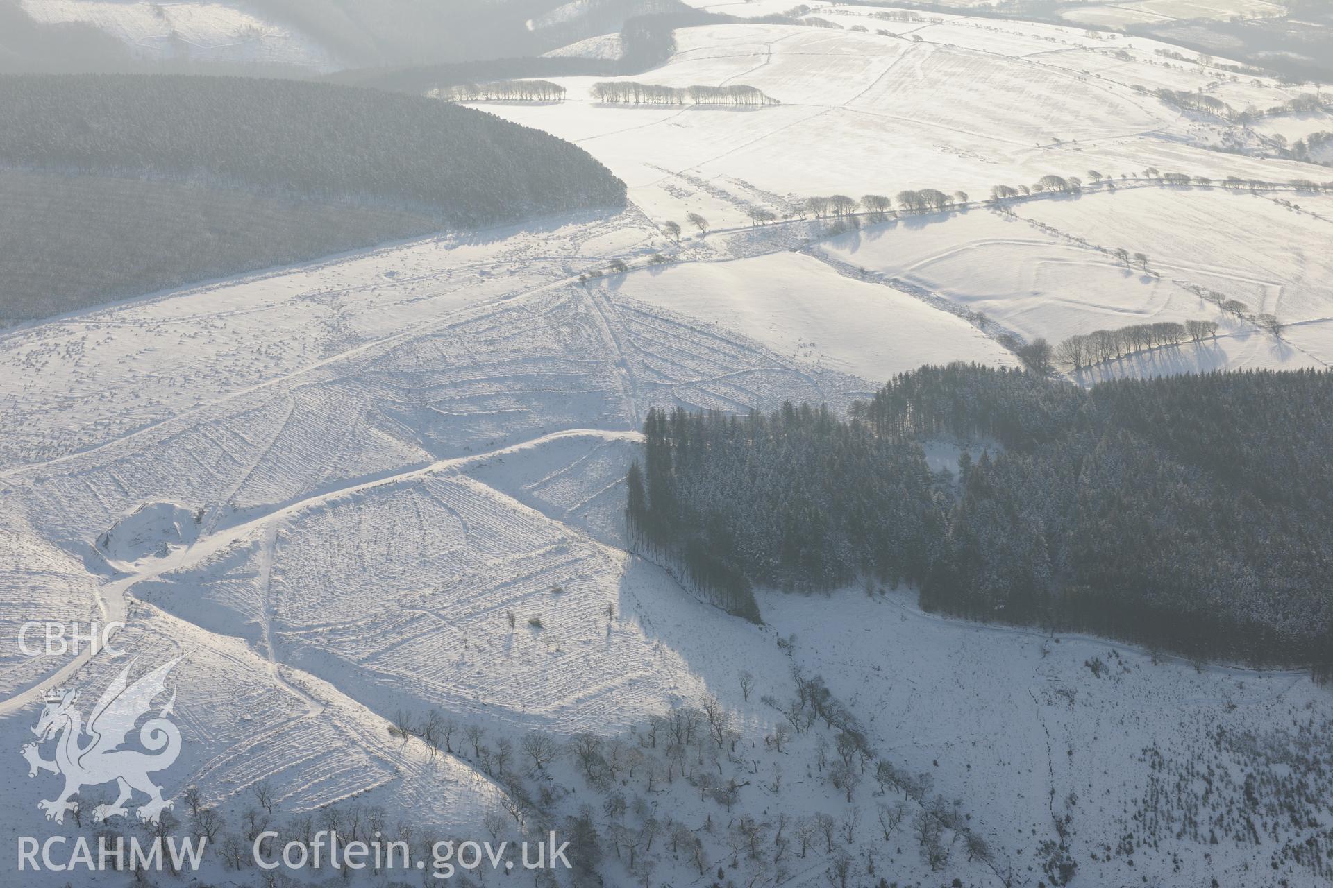 Moel Ton-Mawr hillfort and field system. Oblique aerial photograph taken during the Royal Commission?s programme of archaeological aerial reconnaissance by Toby Driver on 24th January 2013.