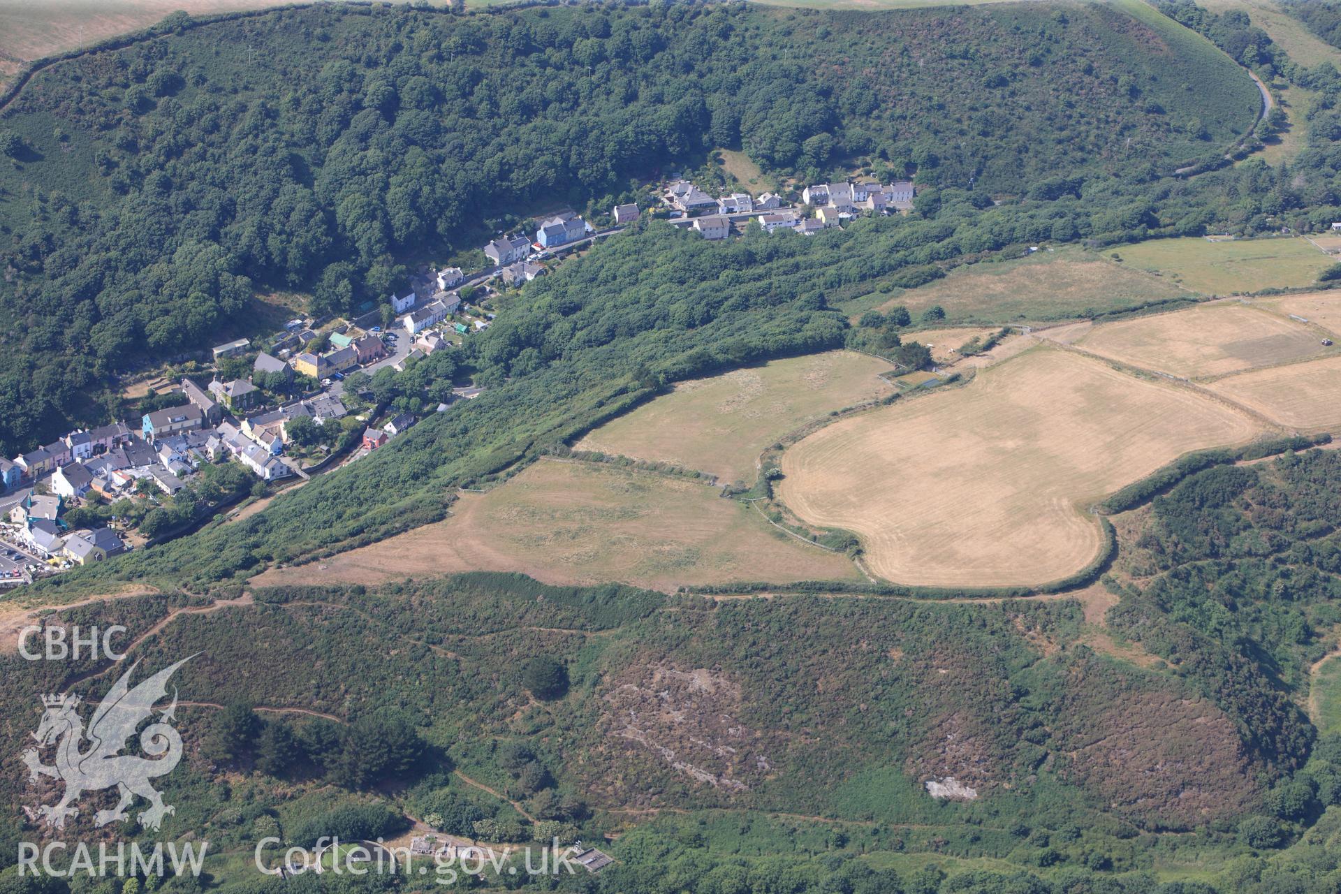 Defended enclosure and the village of Solva. Oblique aerial photograph taken during the Royal Commission?s programme of archaeological aerial reconnaissance by Toby Driver on 16th July 2013.