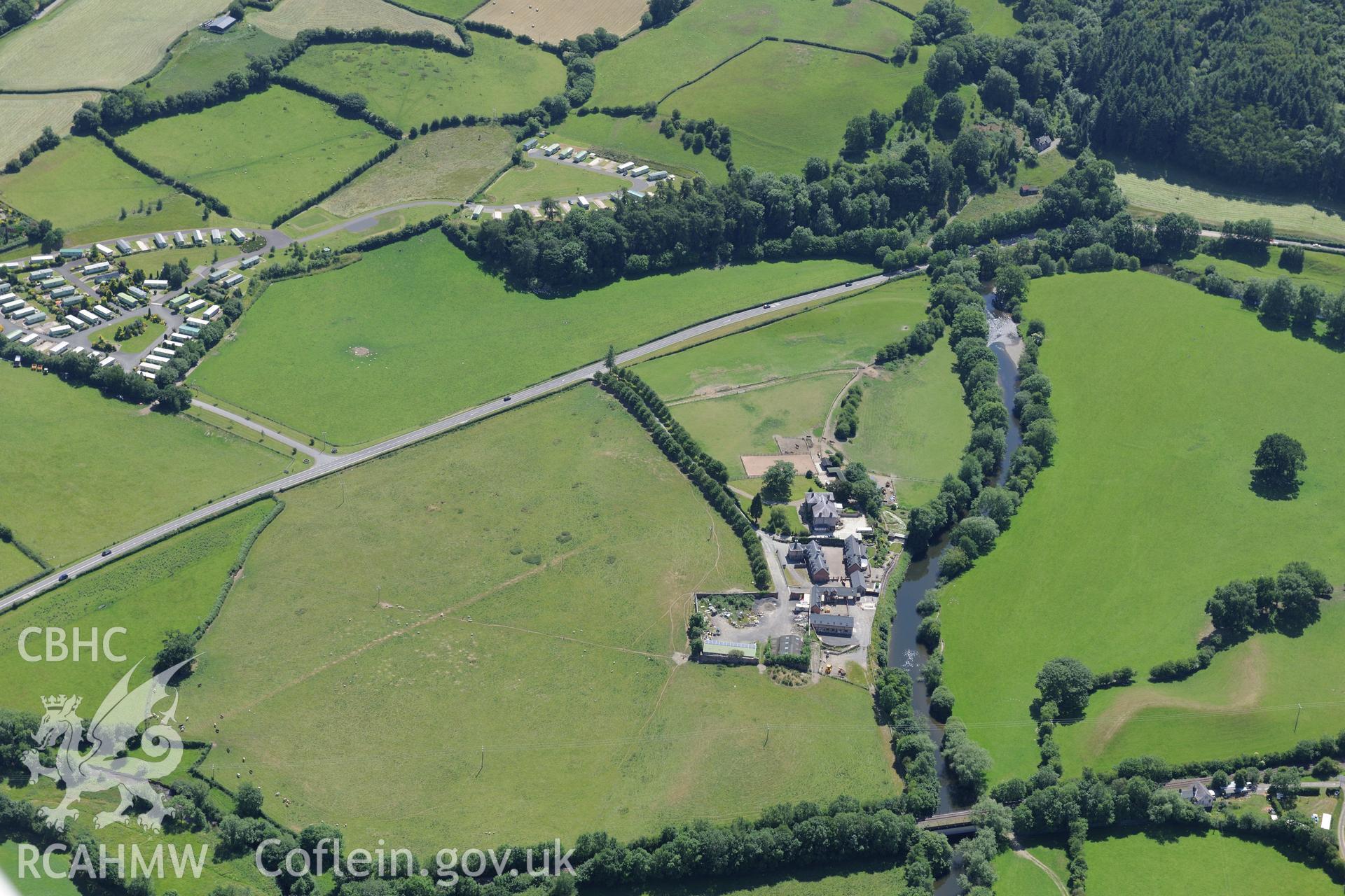 Glanhafren house and garden, and the Roman road which runs through its grounds, west of Newtown. Oblique aerial photograph taken during the Royal Commission's programme of archaeological aerial reconnaissance by Toby Driver on 30th June 2015.