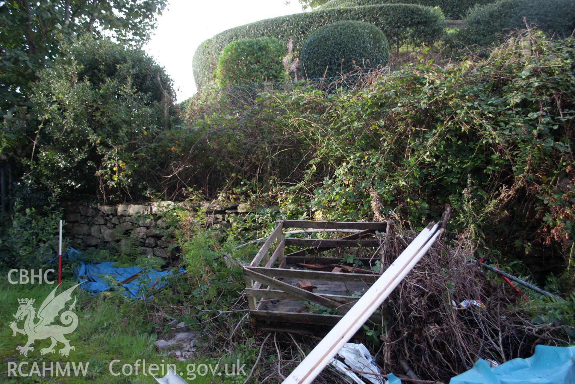 View from the east of former garden/yard retaining wall at southeast end of yard plot at Gwynle, Y Bala. Photographed during archaeological watching brief conducted by Gwynedd Archaeological Trust on 21 September 2018. Project no. G2573.