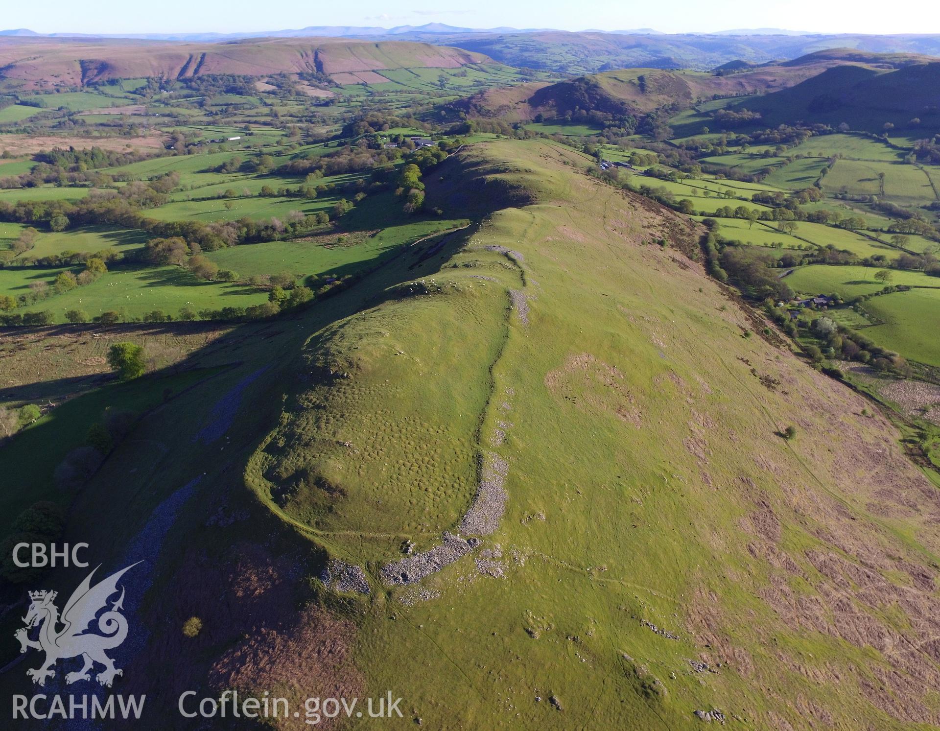 Colour photo showing aerial view of Castle Bank hillfort, Glasgwm, taken by Paul R. Davis, 13th May 2018.