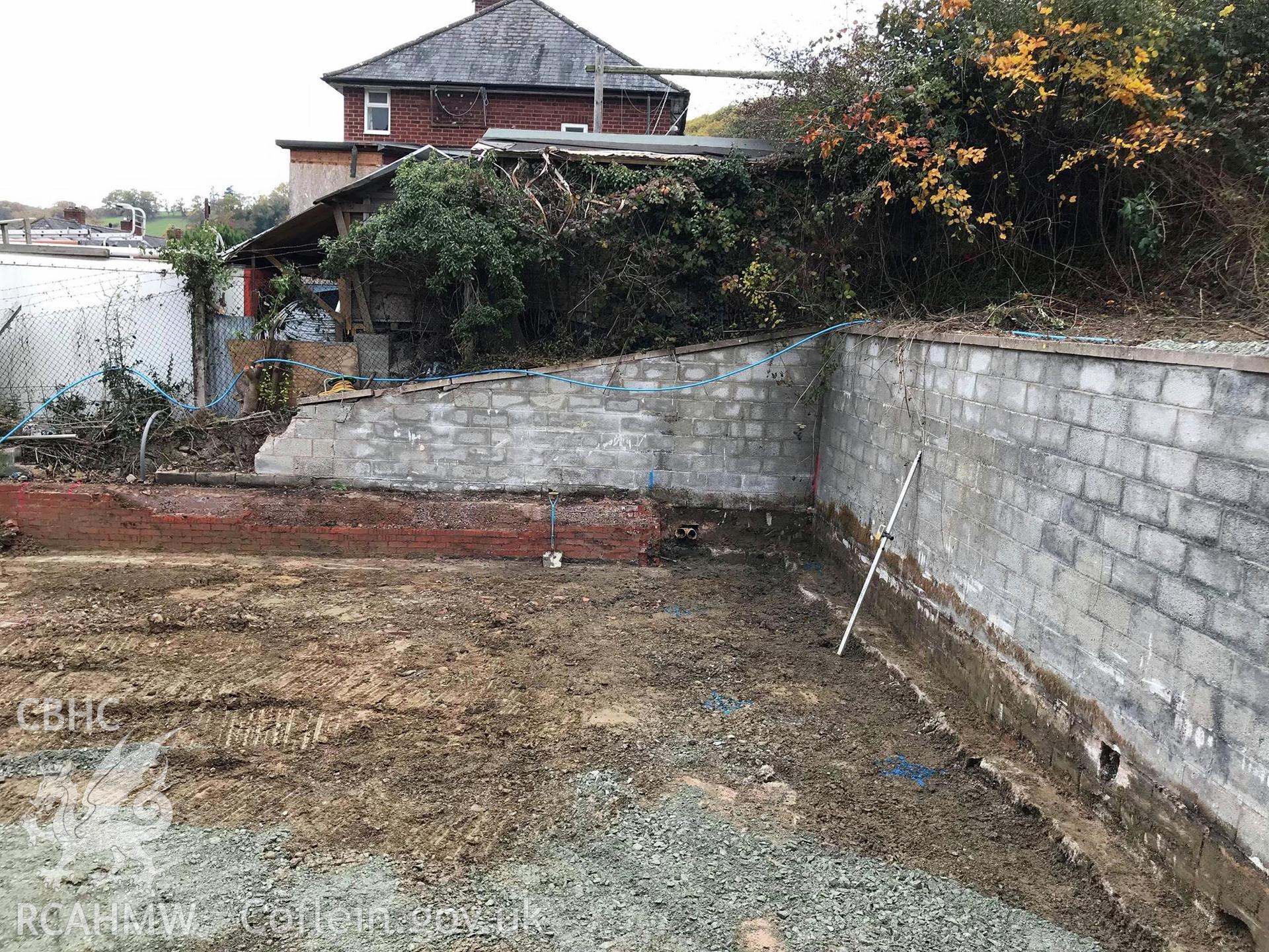 Digital colour photograph showing 'Area A after groundworks, looking west.' Photographed during Archaeological Watching Brief conducted at Welshpool Social Club, Bronybuckley, Welshpool, Powys. Prepared by Archaeology Wales, November 2018. Report no. 1723.