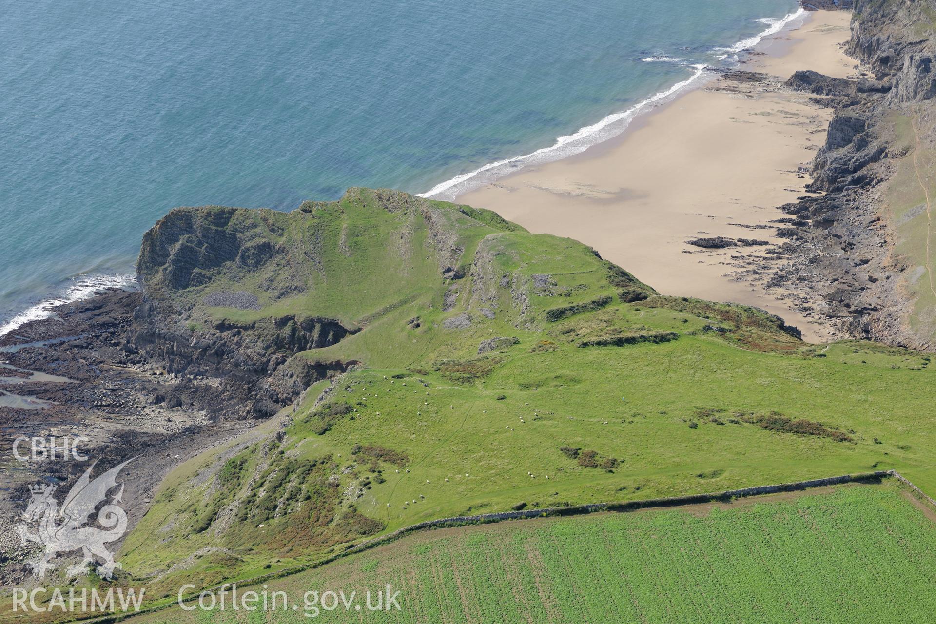 Thurba Camp defended enclosure, south of Rhossili, on the south western coast of the Gower Peninsula. Oblique aerial photograph taken during the Royal Commission's programme of archaeological aerial reconnaissance by Toby Driver on 30th September 2015.