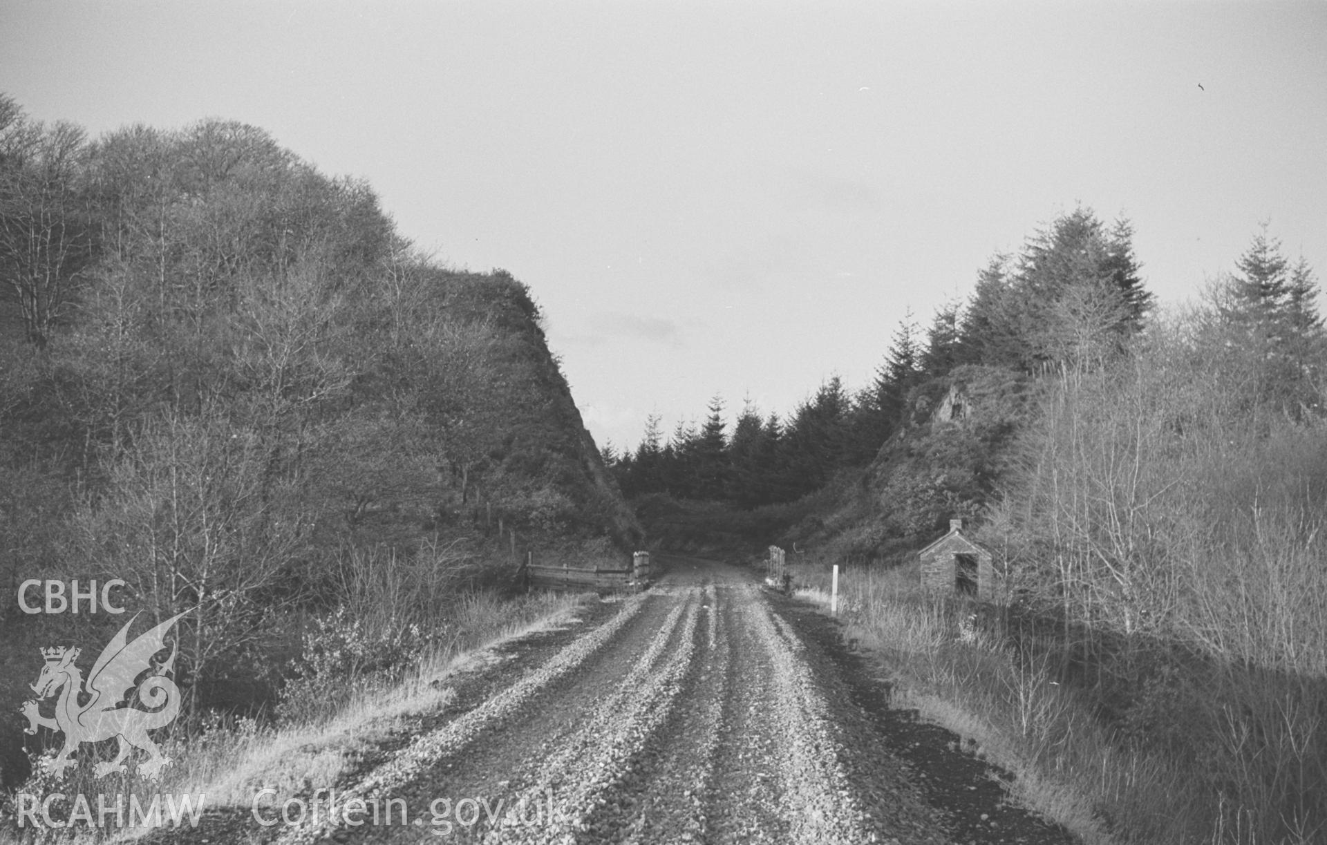 Digital copy of a black and white negative showing disused railway embankment and cutting 800m south south west of Llanafan Bridge. Photographed by Arthur O. Chater on 1st January 1967 looking north north west from Grid Reference SN 6845 7055.