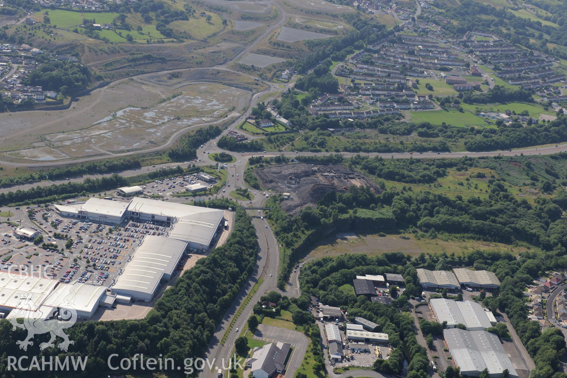 Site of former Rotax factory, and Cyfarthfa Ironworks including the remains of its blast furnaces, under excavation by Glamorgan-Gwent Archaeological Trust. Oblique aerial photograph taken during the Royal Commission?s programme of archaeological aerial reconnaissance by Toby Driver on 1st August 2013.