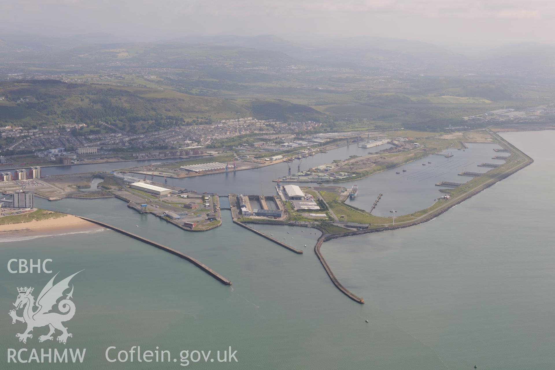 Swansea docks including the King's Dock, Queen's Dock and Prince of Wales Dock, with the city of Swansea in the distance. Oblique aerial photograph taken during the Royal Commission's programme of archaeological aerial reconnaissance by Toby Driver on 19th June 2015.