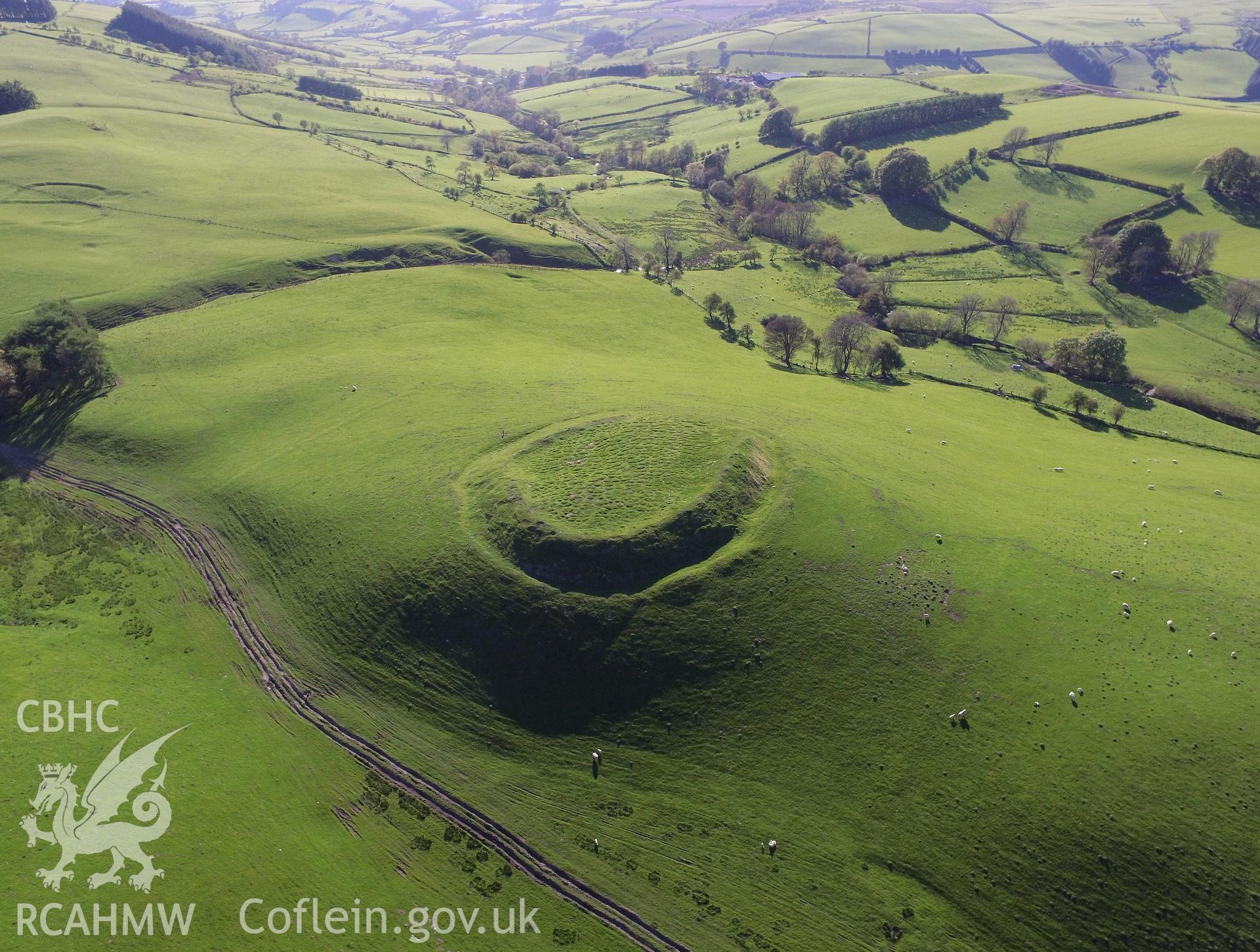 Colour photo showing aerial view of Castell-y-Blaidd, Llanbadarn Fynydd in it's surroundings, taken by Paul R. Davis, 13th May 2018.