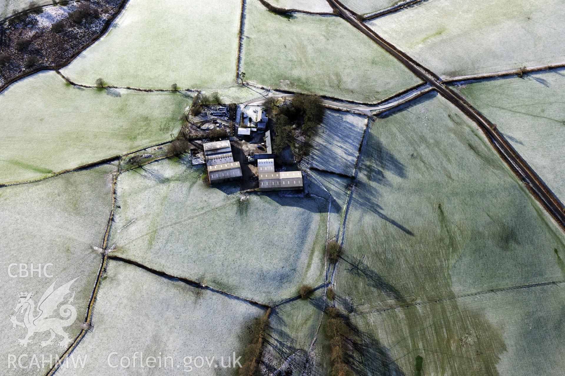 Twdin or Caerau Motte, Caerau Roman fort and military settlement, and the Roman road from Carmarthen to Castell Collen (RR623). Oblique aerial photograph taken during the RCAHMW?s programme of archaeological aerial reconnaissance by Toby Driver 15/01/2013.