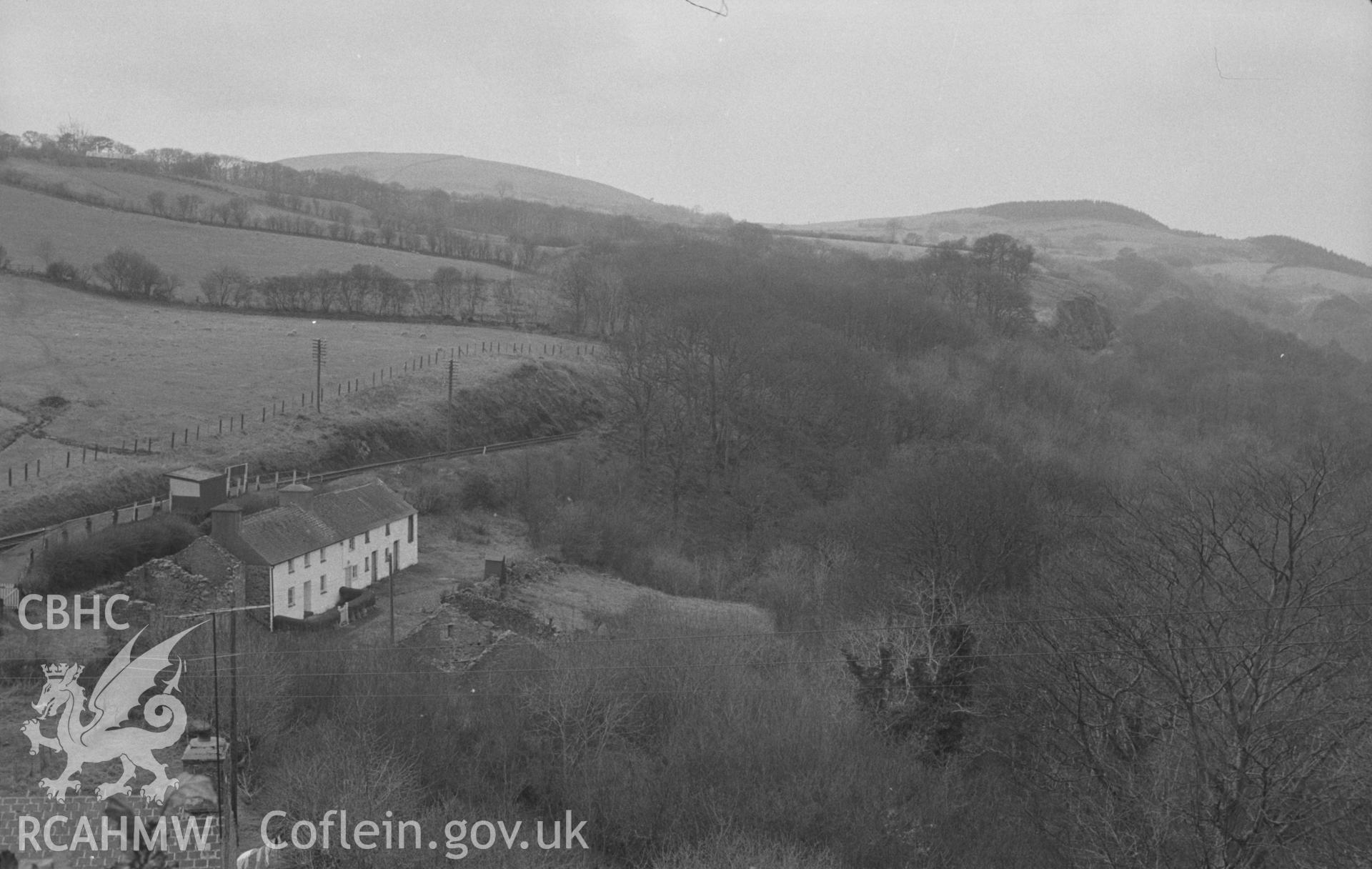 Digital copy of a black & white negative showing view of Coed Berth-Lwyd, looking down the Sychnant from back of Post Office. Caradoc Falls Halt on left. Photographed in April 1964 by Arthur O. Chater from Grid Reference SN 6926 6948, looking north west.