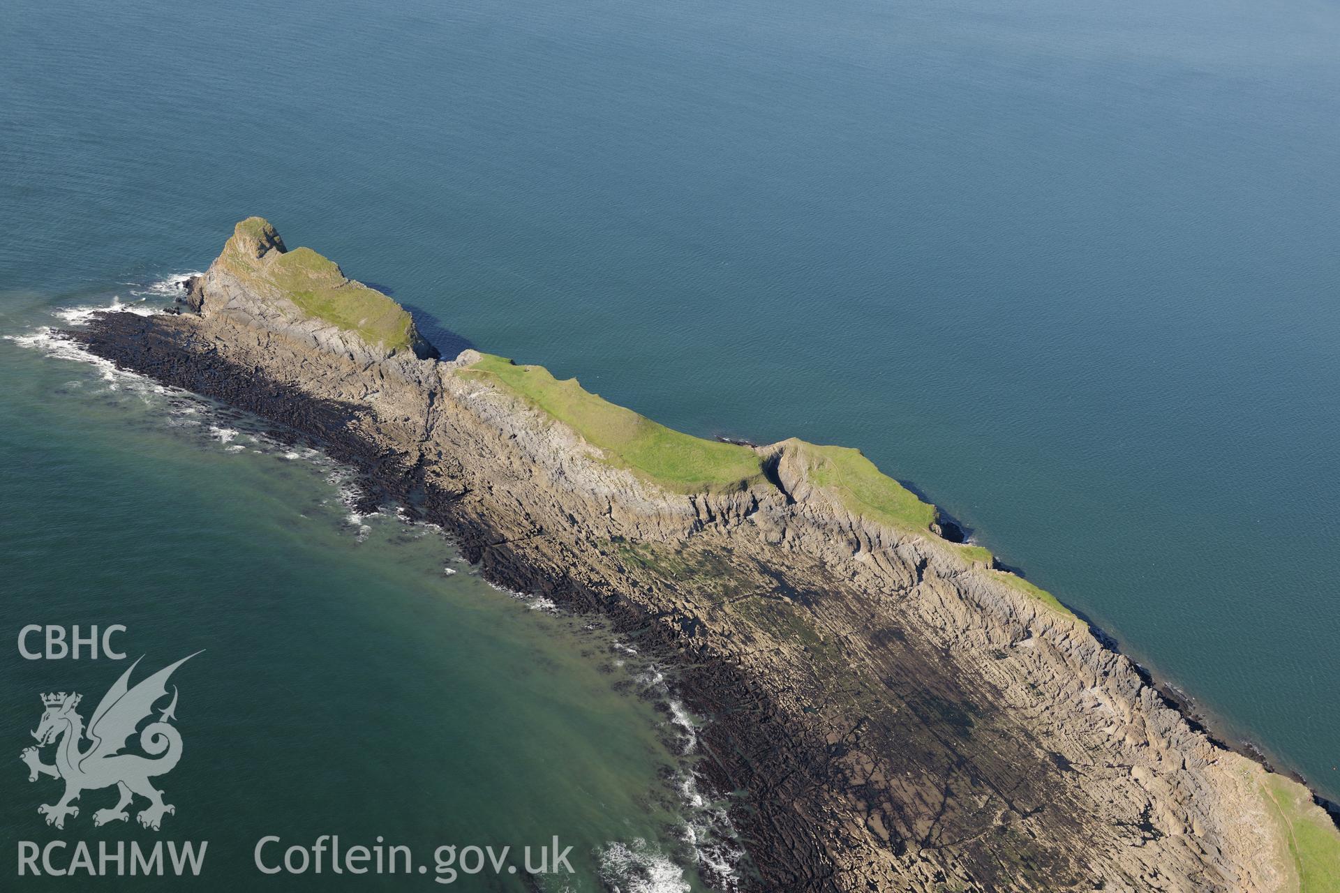 Worms Head, on the western coast of the Gower Peninsula. Oblique aerial photograph taken during the Royal Commission's programme of archaeological aerial reconnaissance by Toby Driver on 30th September 2015.