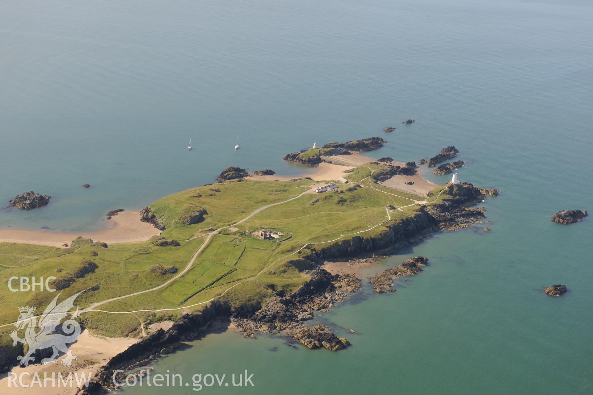 The lighthouse, tower, pilot's house and St. Dwynwen's Church on Llanddwyn Island. Oblique aerial photograph taken during the Royal Commission's programme of archaeological aerial reconnaissance by Toby Driver on 23rd June 2015.