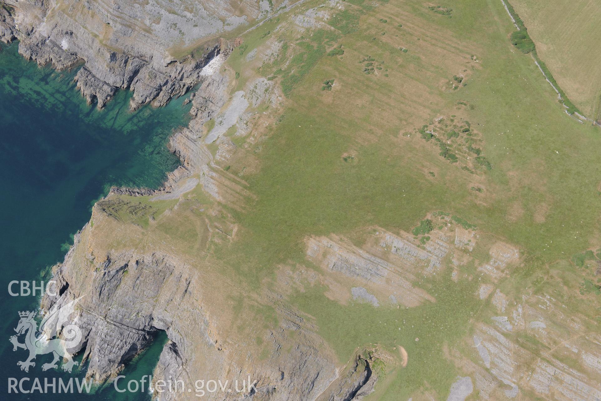 Horse Cliff Promontory Fort, on the south western coast of the Gower. Oblique aerial photograph taken during the Royal Commission?s programme of archaeological aerial reconnaissance by Toby Driver on 16th July 2013.