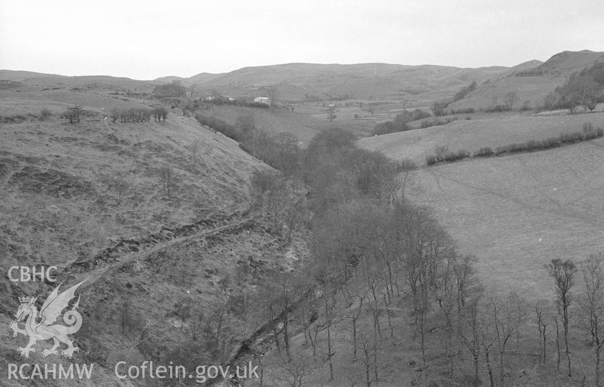 Digital copy of black & white negative showing view looking up the afon Tuen, showing aqueduct of Cwm Rheidol mine on left and Pen-Rhiw Farm in middle distance. Photographed by Arthur O. Chater in April 1966 from Grid Reference SN 738 778, looking north.