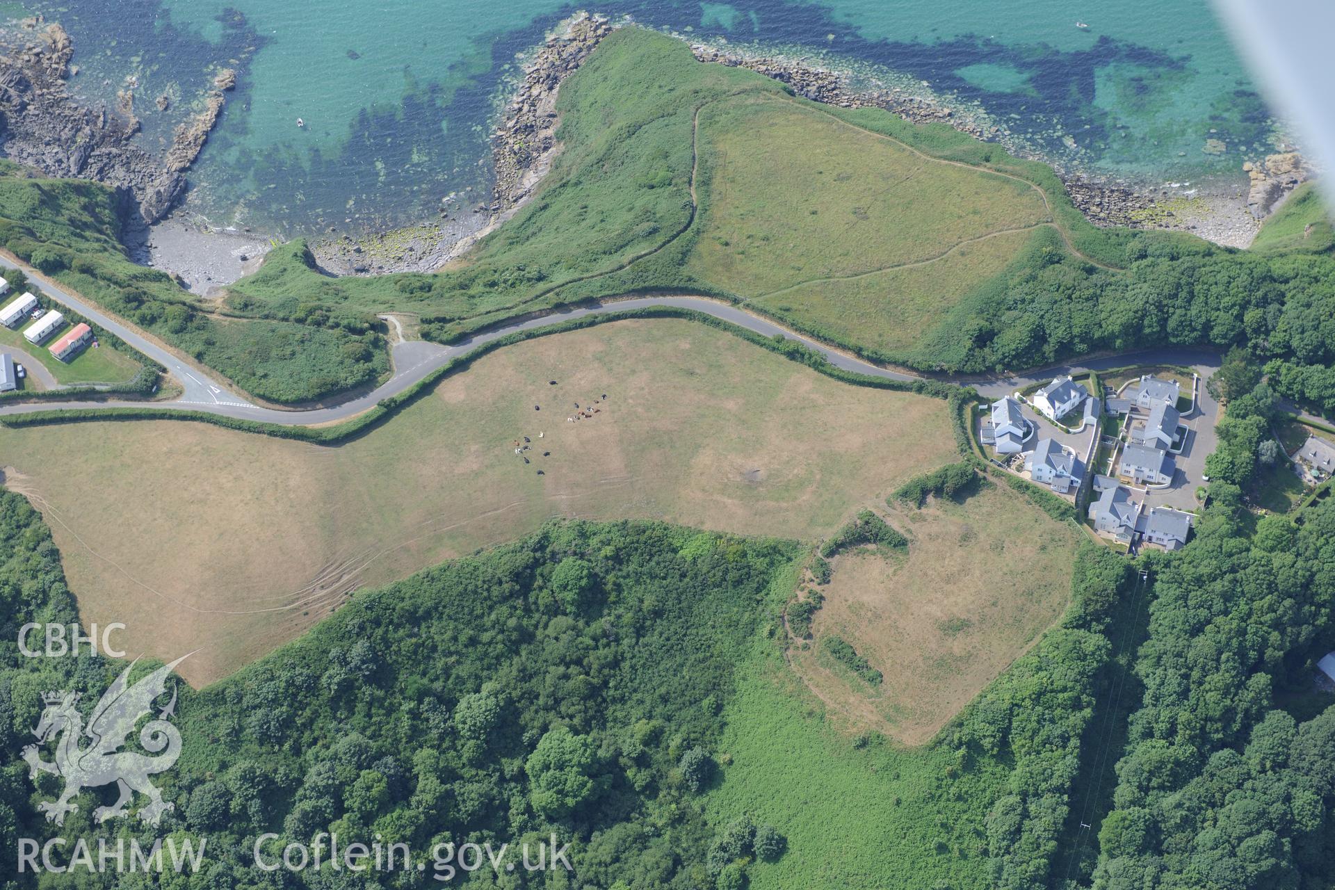 Woodlands defended enclosure, Little Haven. Oblique aerial photograph taken during the Royal Commission?s programme of archaeological aerial reconnaissance by Toby Driver on 16th July 2013.