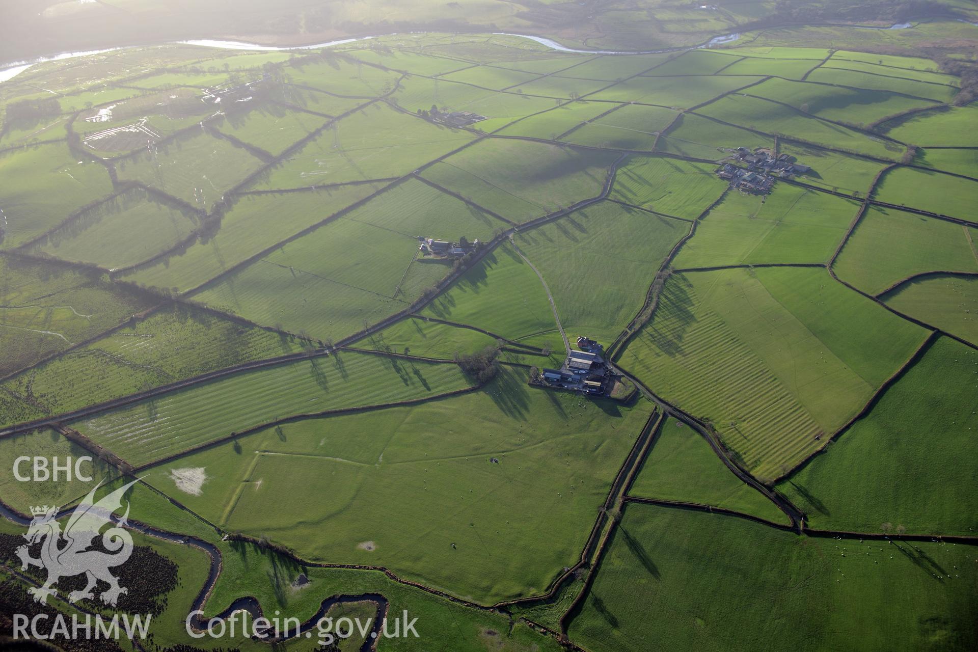View of Brynhelyg Mound; Lanfro Farm; Maen Llwyd and Lower Court Standing Stones; deserted rural settlement. Oblique aerial photograph taken during the Royal Commission's programme of archaeological aerial reconnaissance by Toby Driver on 6th January 2015.