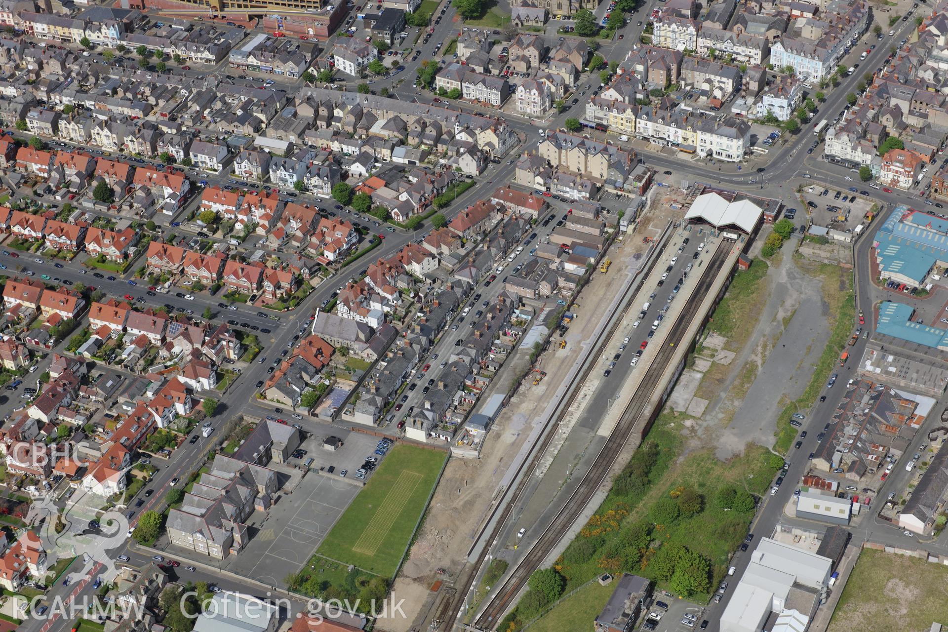 Llandudno Railway Station, and Ysgol Tudno Central School in the town of Llandudno. Oblique aerial photograph taken during the Royal Commission?s programme of archaeological aerial reconnaissance by Toby Driver on 22nd May 2013.