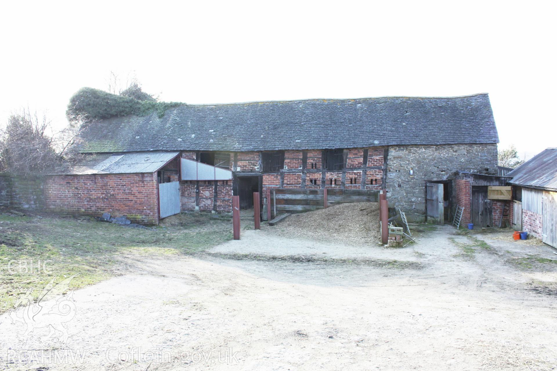 Colour photograph showing red brick and stone exterior of outbuilding at Leighton Farm. Photographed during survey conducted by Geoff Ward on 11th July 2009.