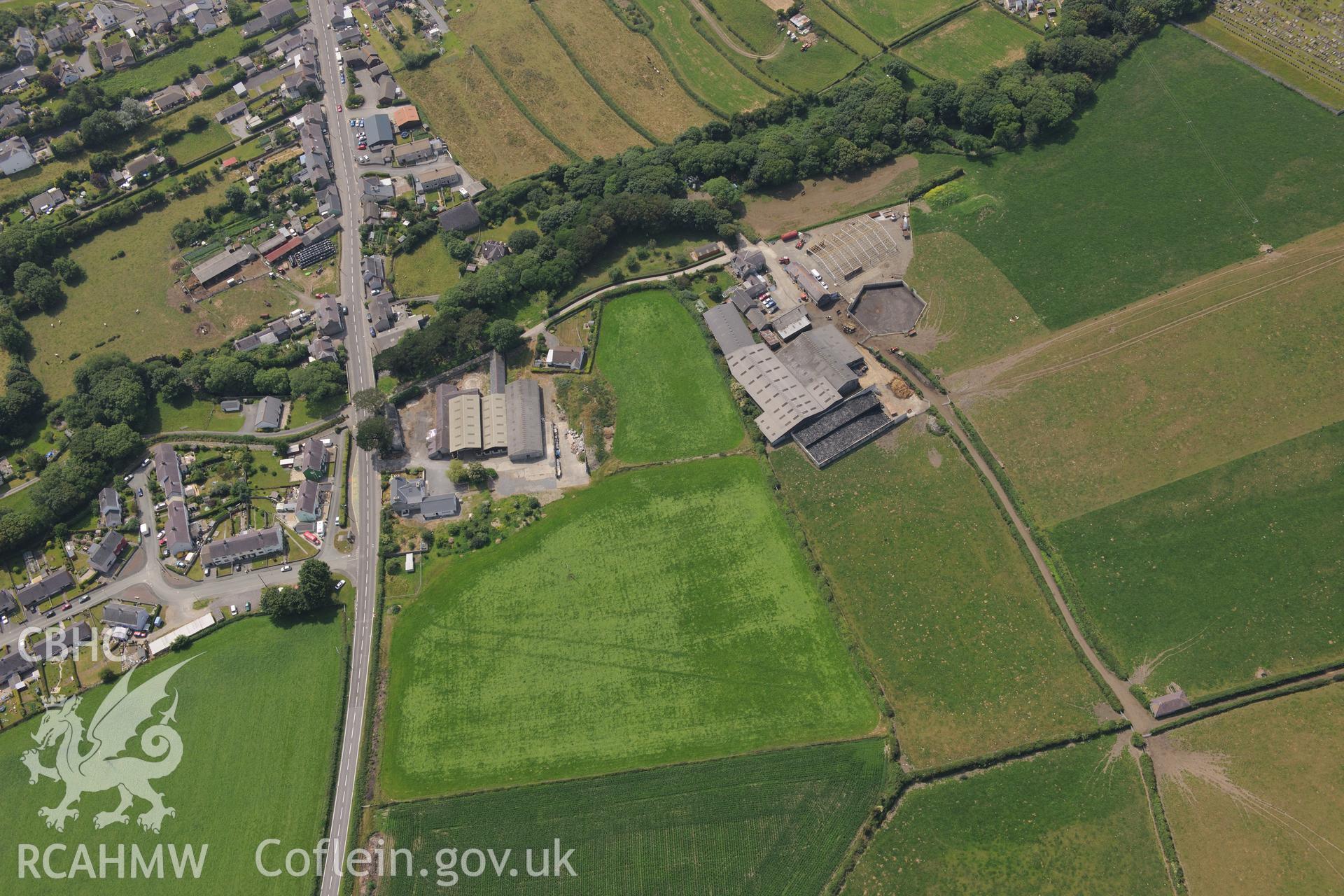 Double ditches at Penlon Farm, Llanon, Aberystwyth. Oblique aerial photograph taken during the Royal Commission?s programme of archaeological aerial reconnaissance by Toby Driver on 12th July 2013.