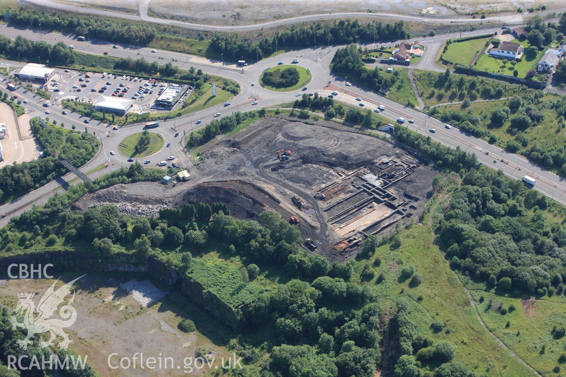 Site of former Rotax factory, and Cyfarthfa Ironworks including the remains of its blast furnaces, under excavation by Glamorgan-Gwent Archaeological Trust. Oblique aerial photograph taken during the Royal Commission?s programme of archaeological aerial reconnaissance by Toby Driver on 1st August 2013.