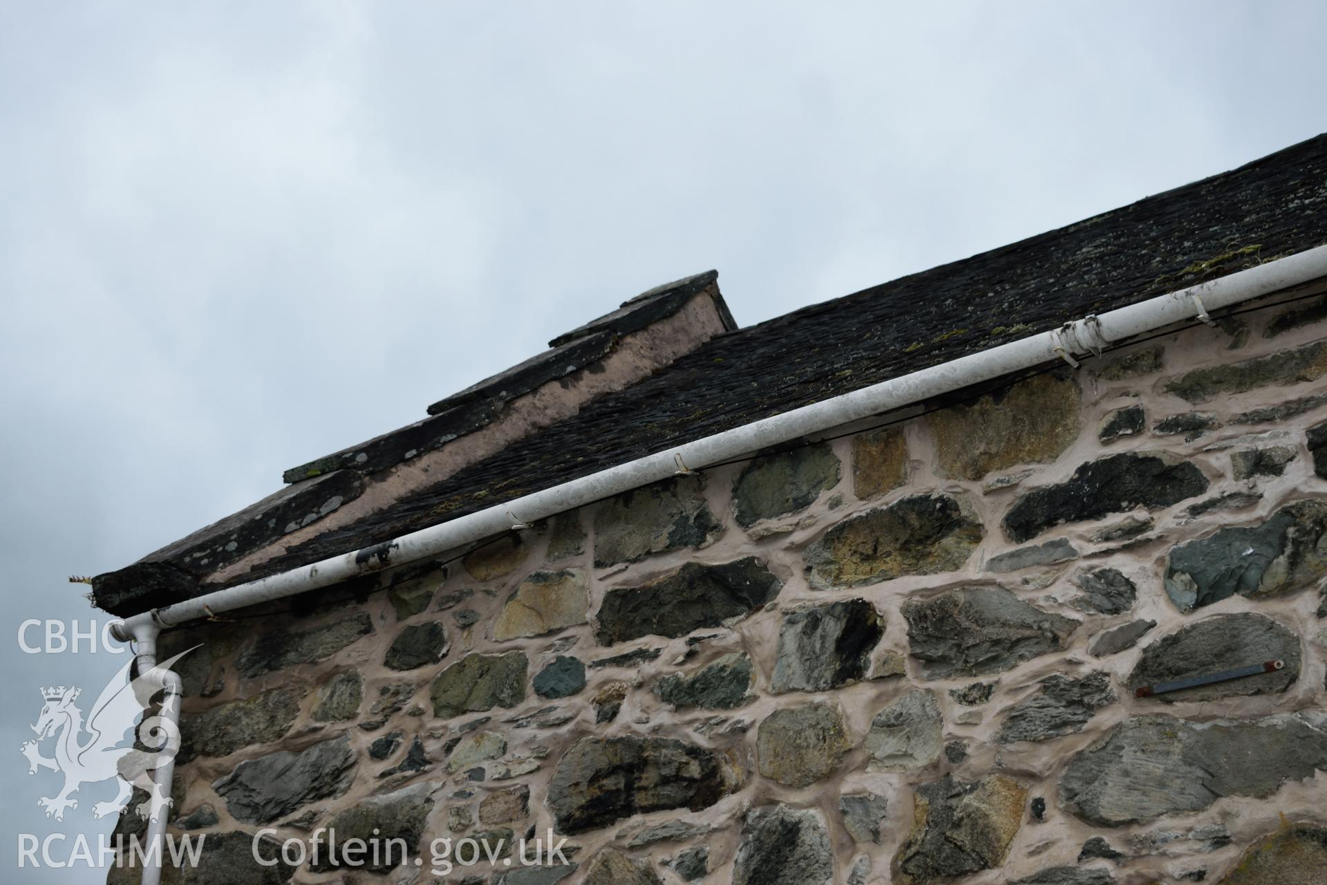 Colour photograph showing view looking south west at the parapet on the eastern elevation of Y Sospan, Llys Owain, Dolgellau. Photographed by I. P. Brookes of Engineering Archaeological Services, June 2019.