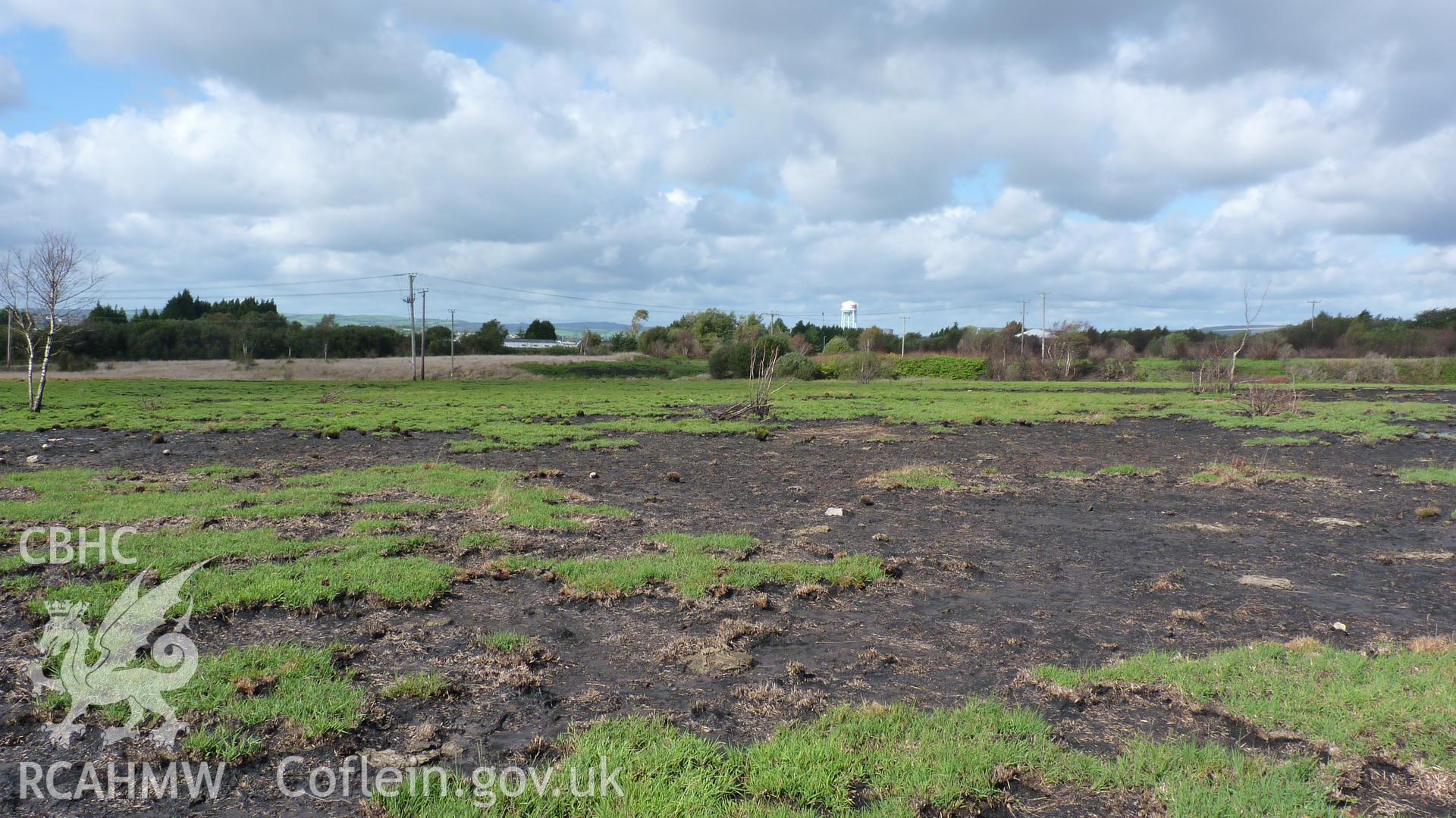 View north towards Carn Goch, with damage from grass fires visible in the foreground. Photographed during Setting Impact Assessment of Land off Phoenix Way, Garngoch Business Village, Swansea, carried out by Archaeology Wales, 2018. Project number P2631.