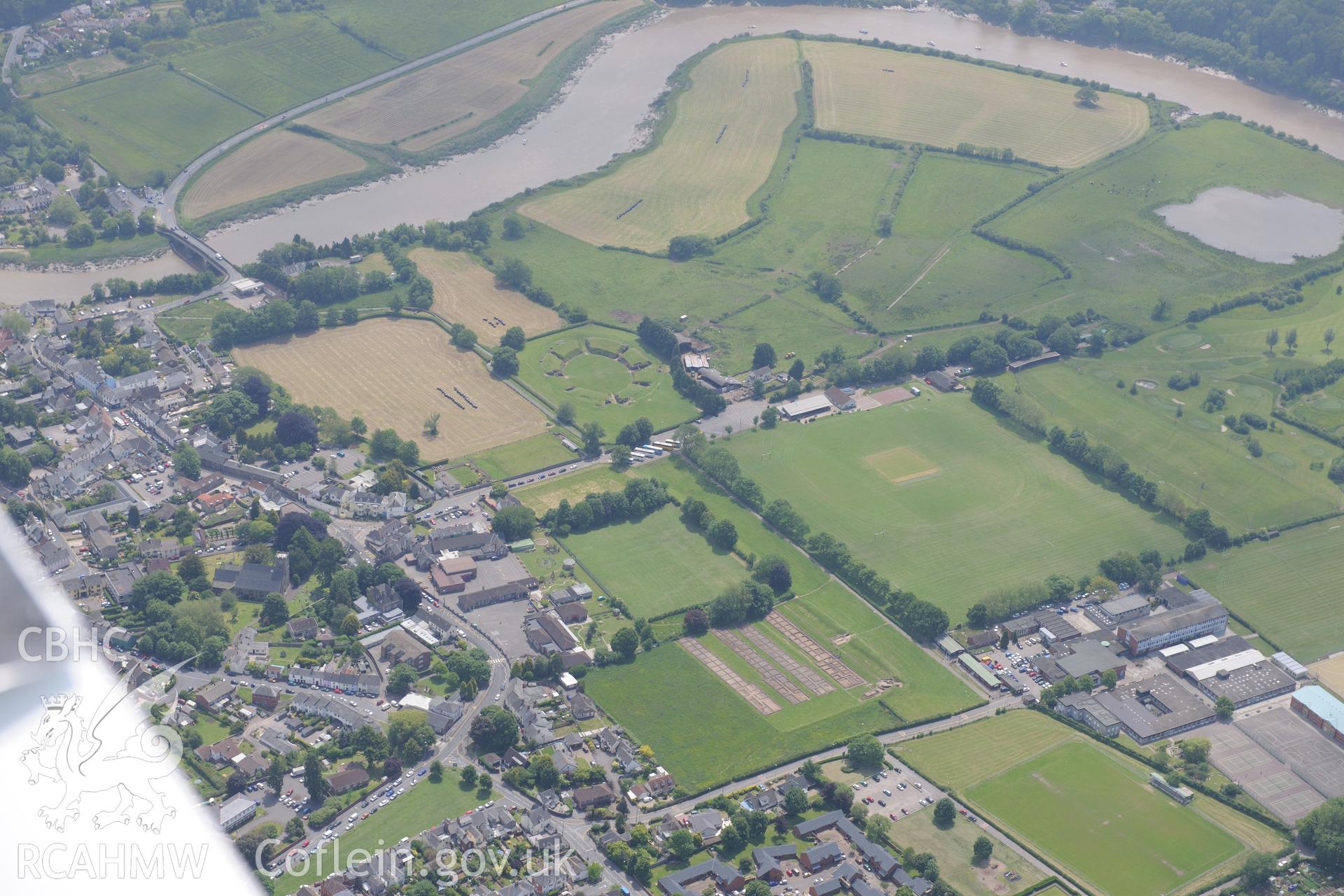 Caerleon town including Roman barracks; amphitheatre & parade grounds plus Caerleon bridge & St. Cadoc's Church. Oblique aerial photograph taken during the Royal Commission's programme of archaeological aerial reconnaissance by Toby Driver on 11 June 2015.