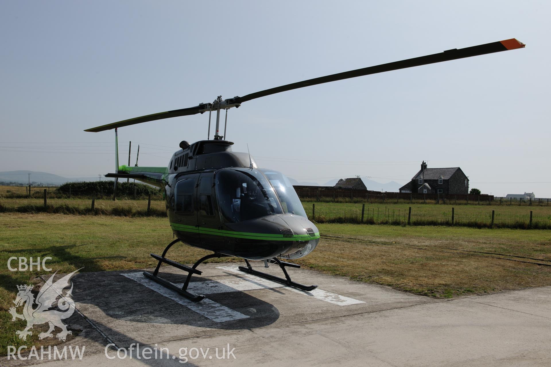 Bell Jetranger at Caernarfon airfield, Llandwrog. Oblique aerial photograph taken during the Royal Commission?s programme of archaeological aerial reconnaissance by Toby Driver on 12th July 2013.