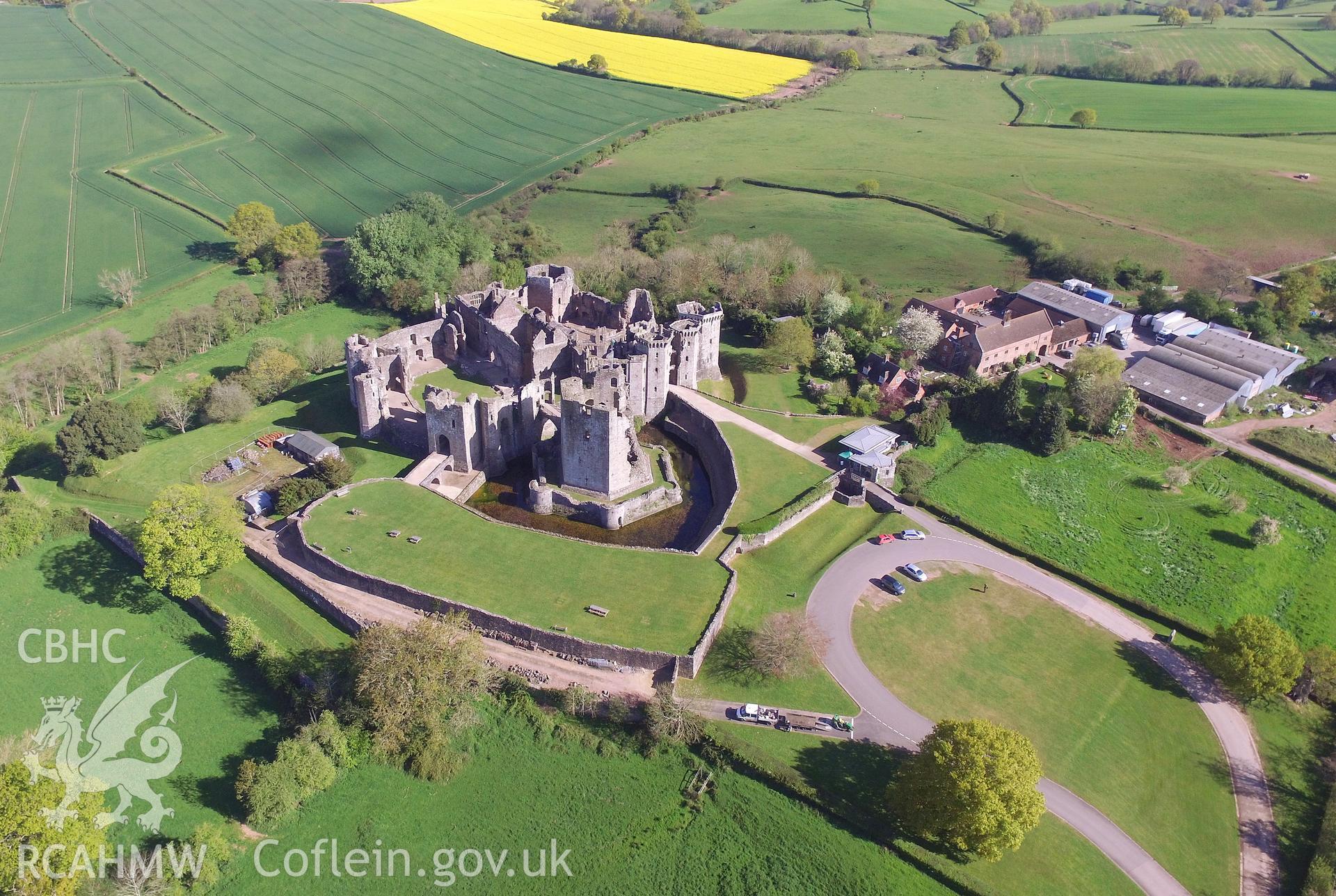 Aerial view from the south of Raglan Castle and Castle Farm, Raglan. Colour photograph taken by Paul R. Davis on 26th April 2017.