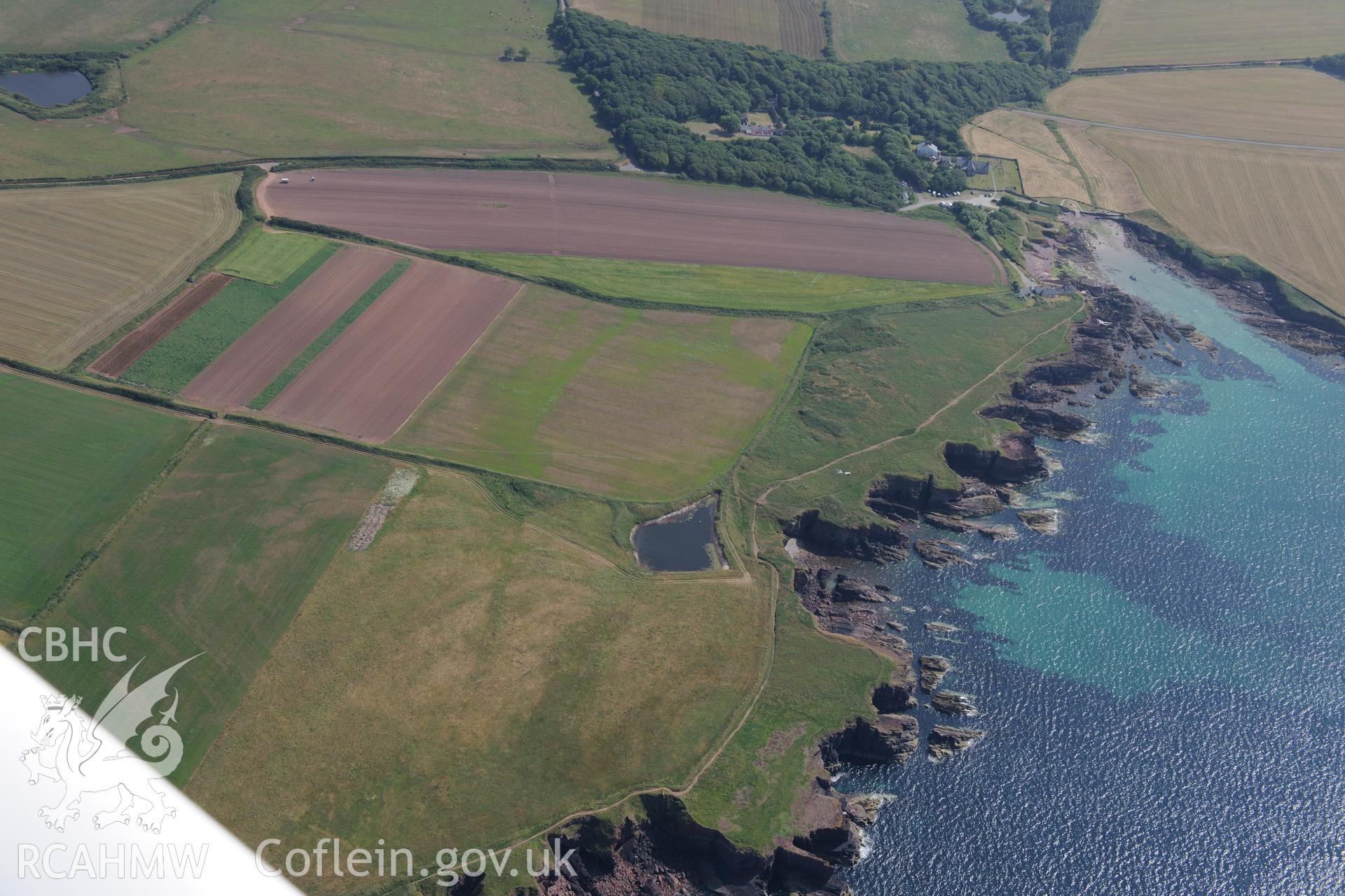 St Bride's Church, St Bride's Green and the Abbey at St Brides, north west of Milford Haven. Oblique aerial photograph taken during the Royal Commission?s programme of archaeological aerial reconnaissance by Toby Driver on 16th July 2013.